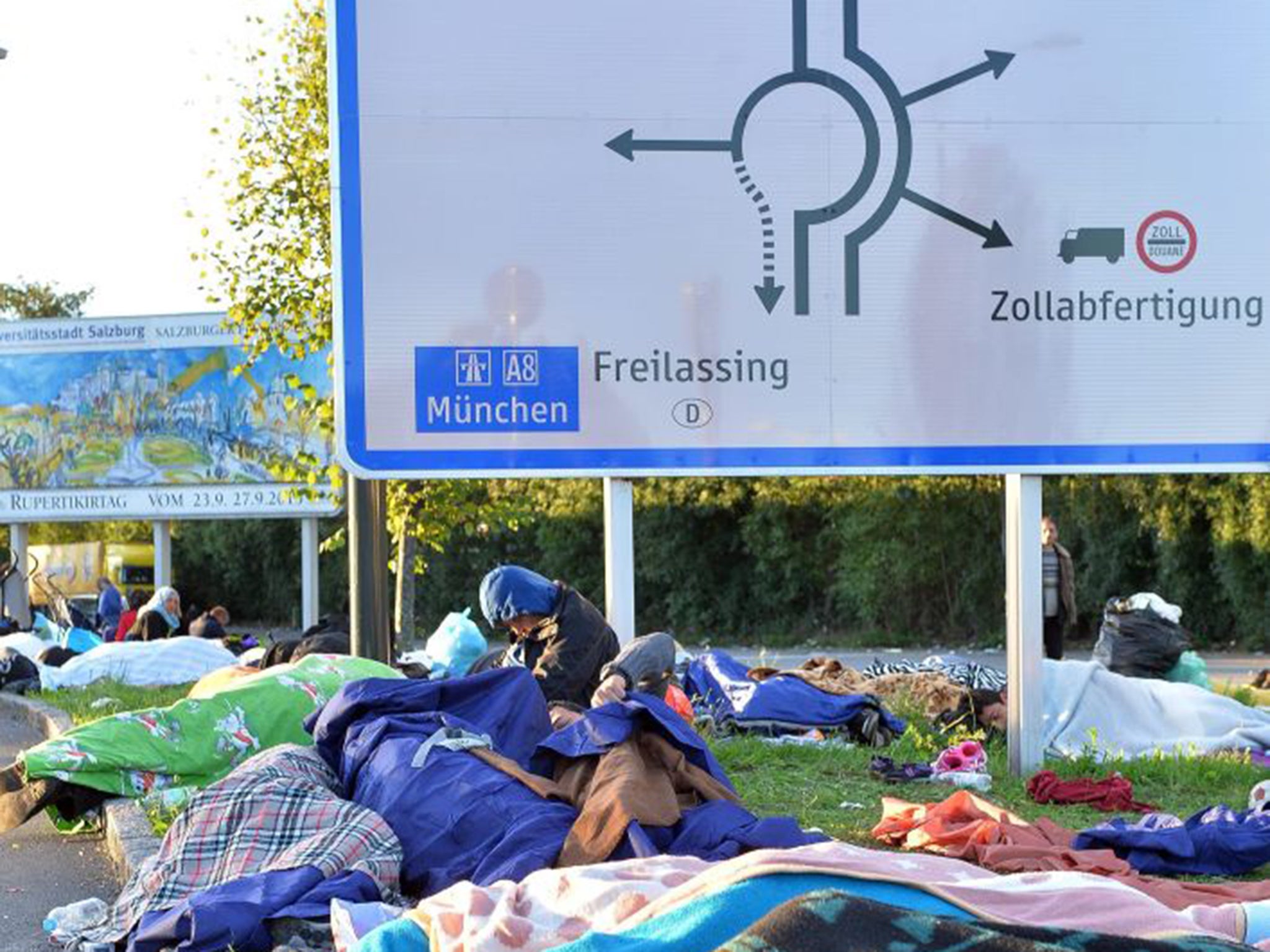 Refugees are forced to sleep outdoors at the Austrian-German border in Freilassing after Germany imposed immediate emergency border controls with Austria