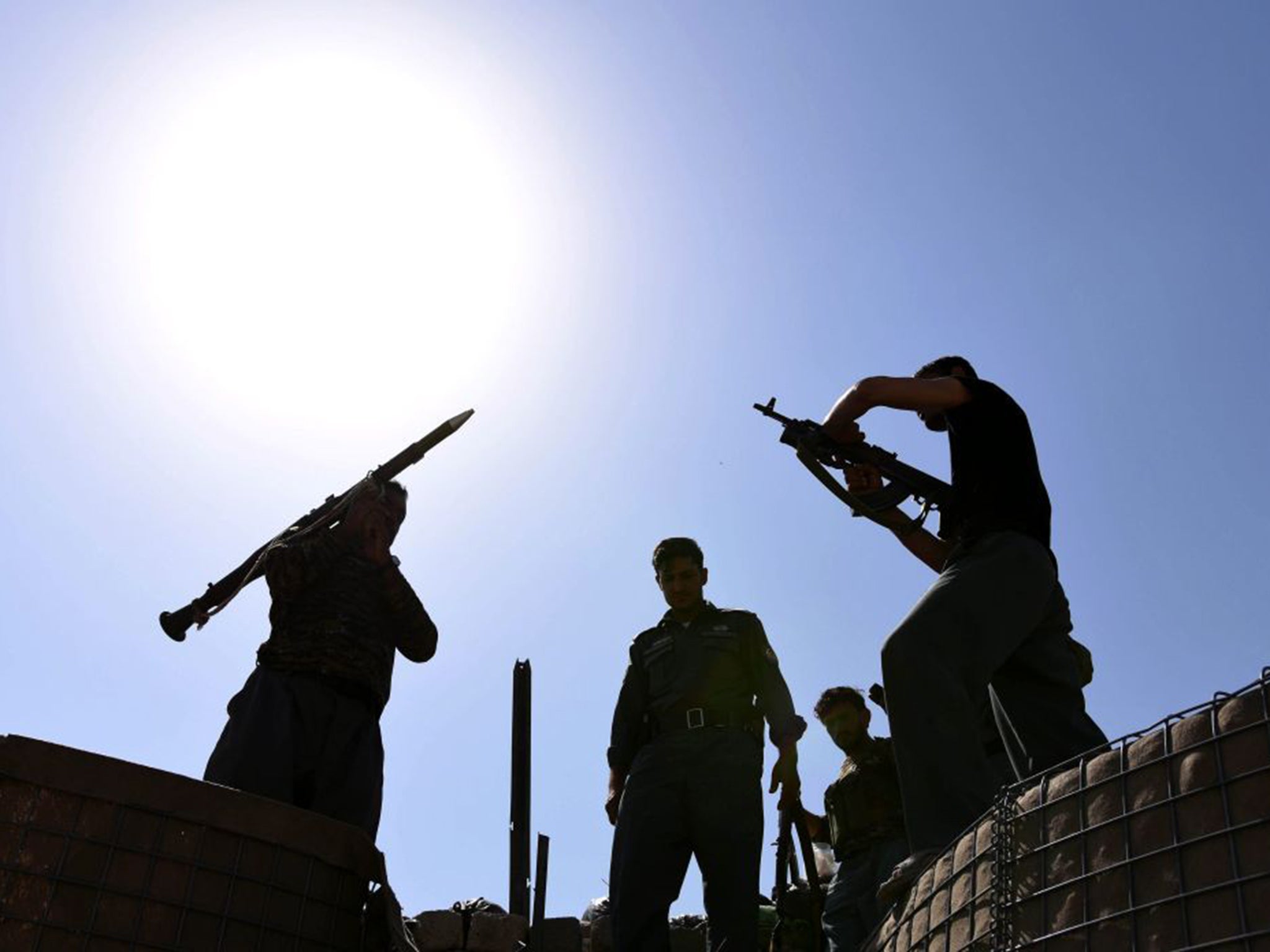 Afghan security forces prepare weapons to fight off the Taliban in Kunduz, where the militants are in control of most of the city