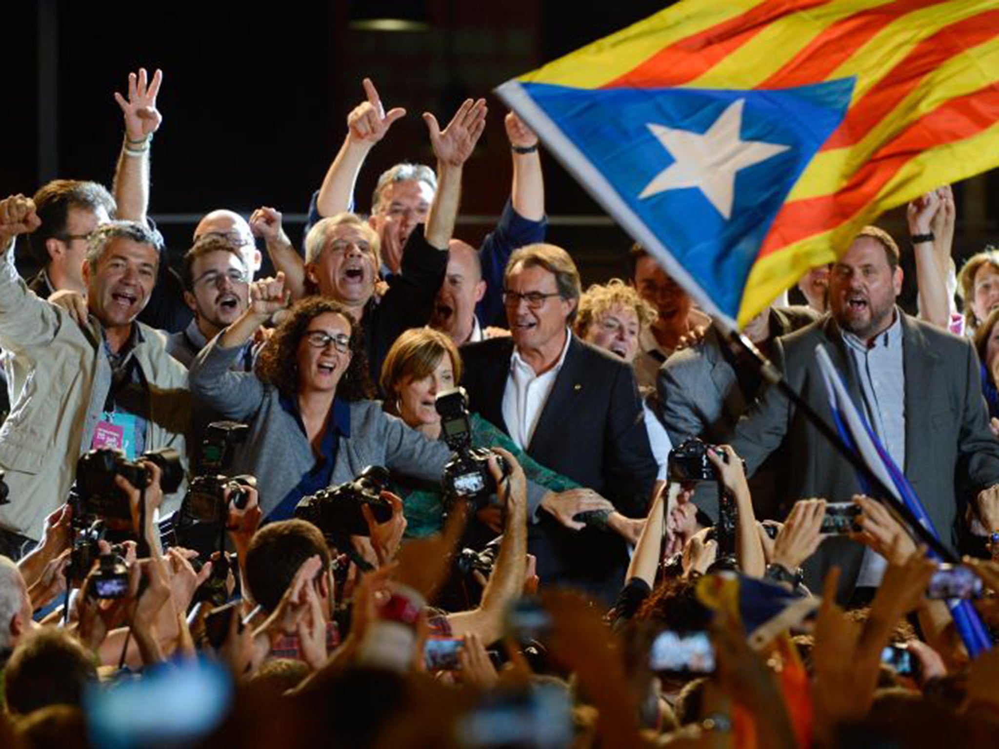 Jubilant leader of Junts Pel Sí Artur Mas, centre, celebrates with his supporters