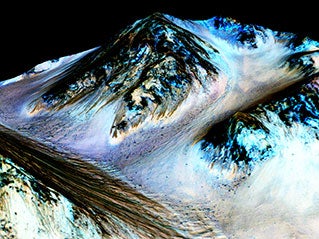 The dark narrow streaks on the slopes are believed to be formed by seasonal water flow on Mars