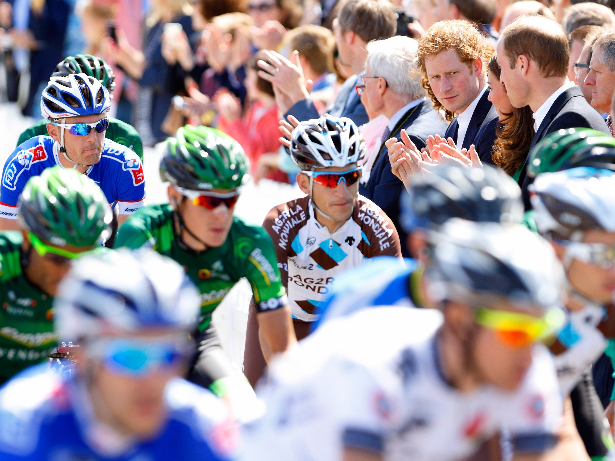 Prince Harry, Catherine, Duchess of Cambridge and Prince William, Duke of Cambridge watch the Tour de France Grand Depart in Leeds