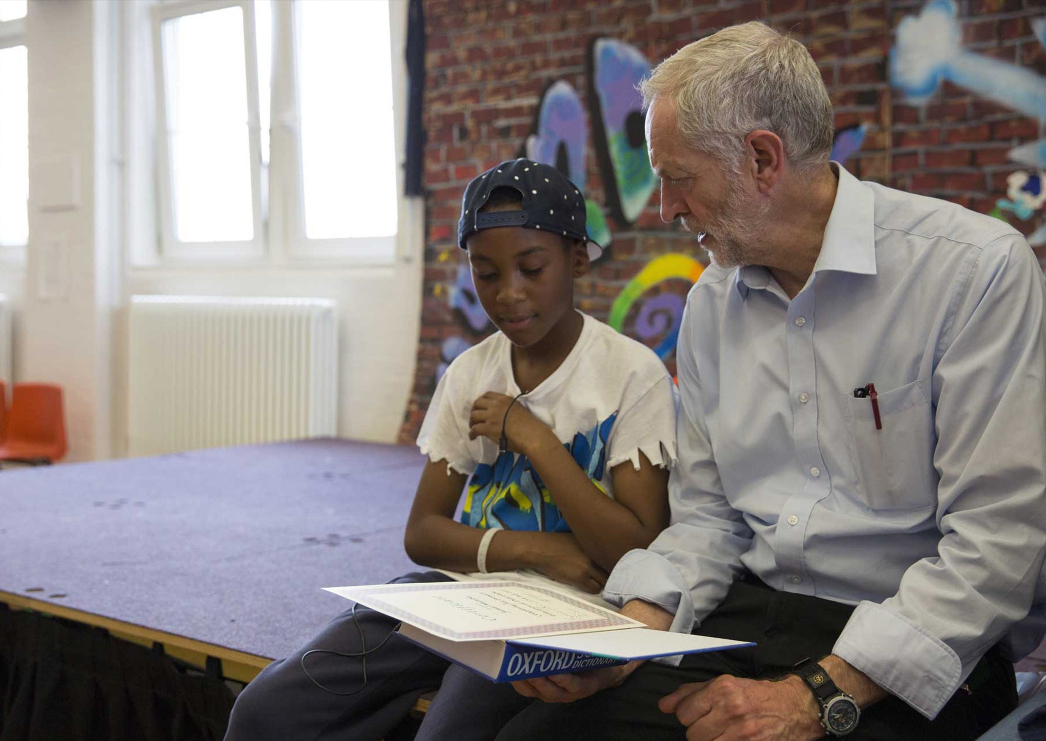 Jeremy Corbyn presents pupils with certificates after they perform in a play on their last day of school at Duncombe Primary School on July 16, 2015 in London, England.