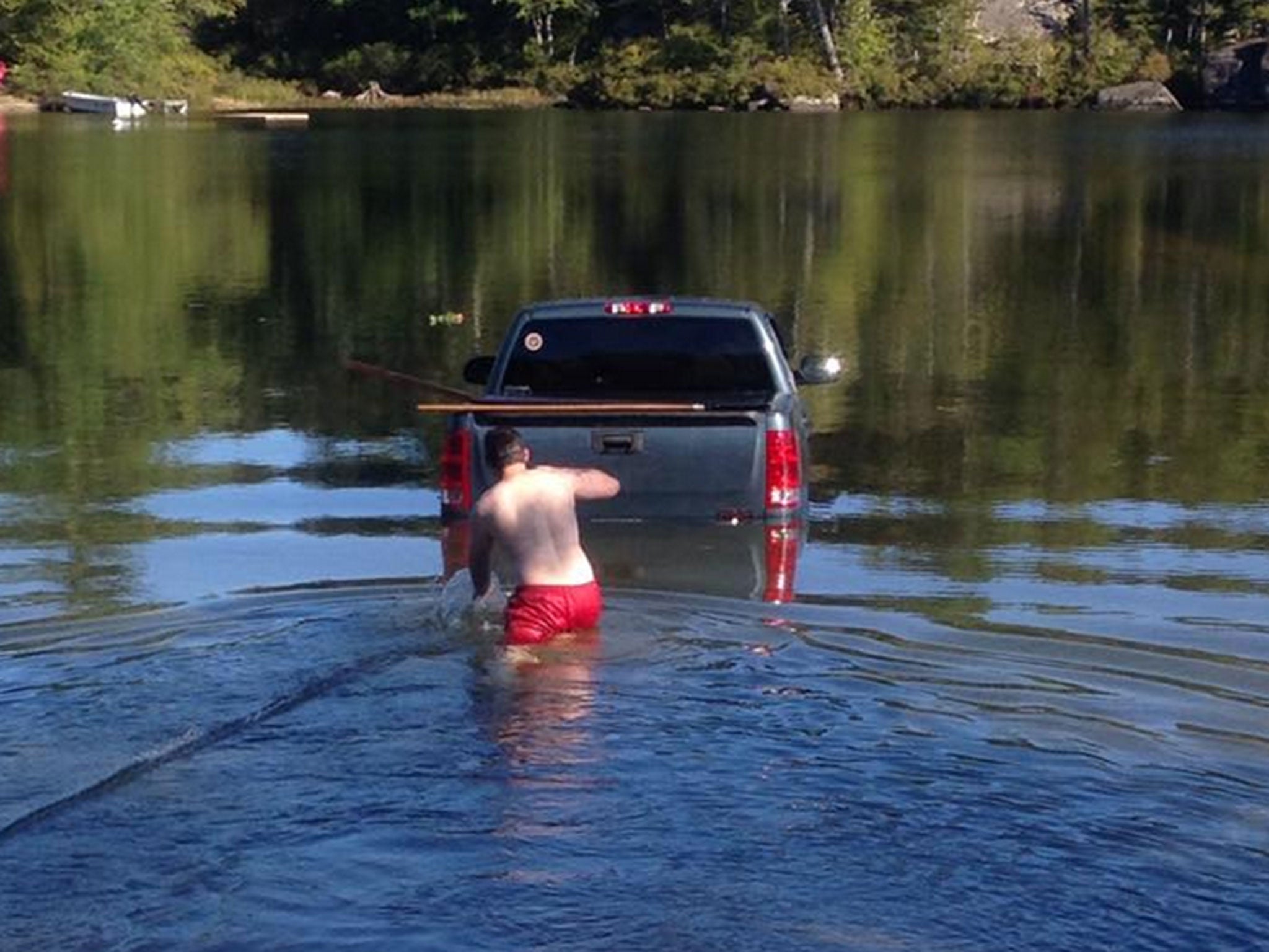 The Yorkshire Terrier was rescued from the truck, but the owner's vehicle was a total loss after it was towed from the lake