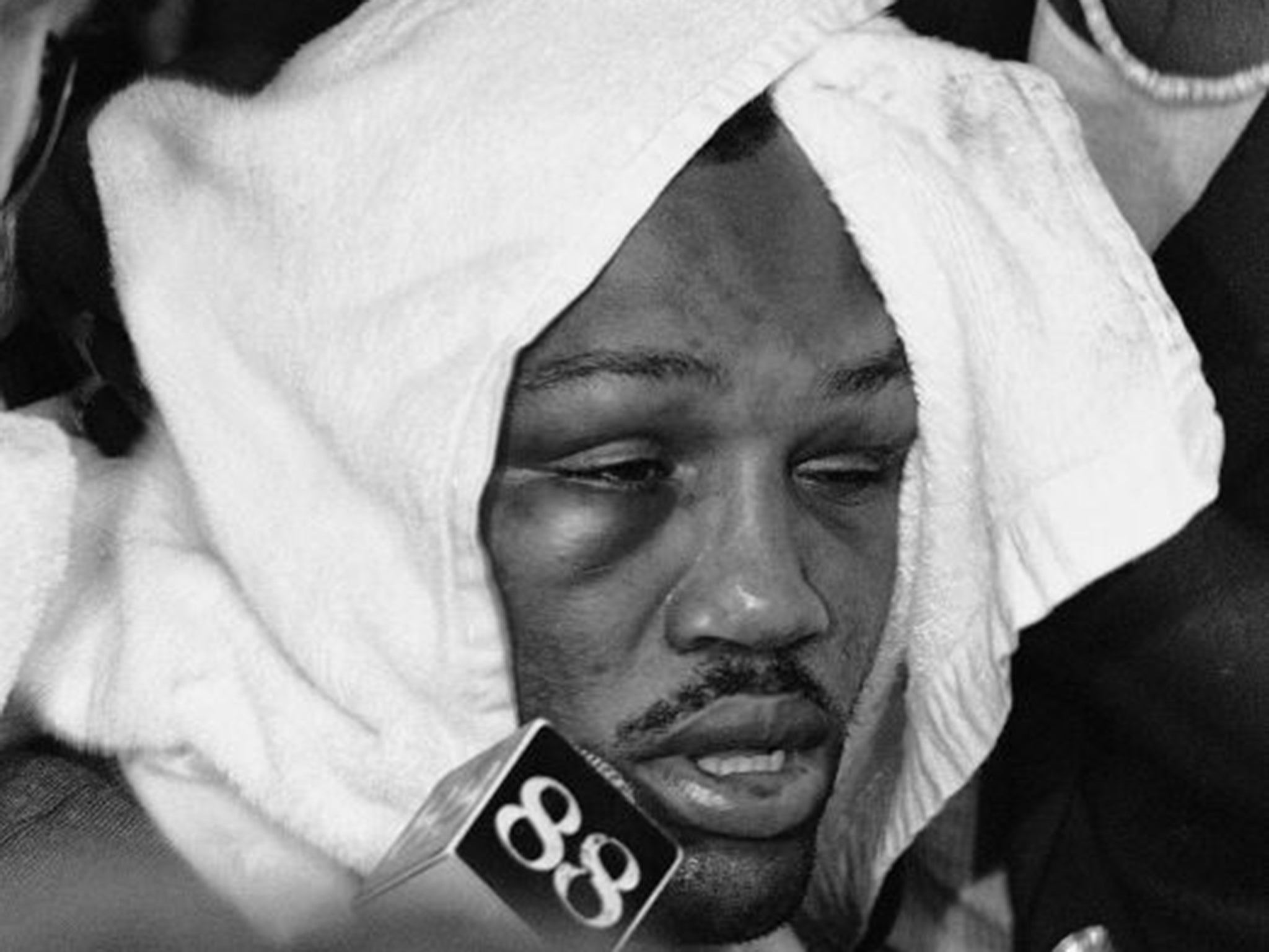 Beaten Joe Frazier speaks with reporters after the fight