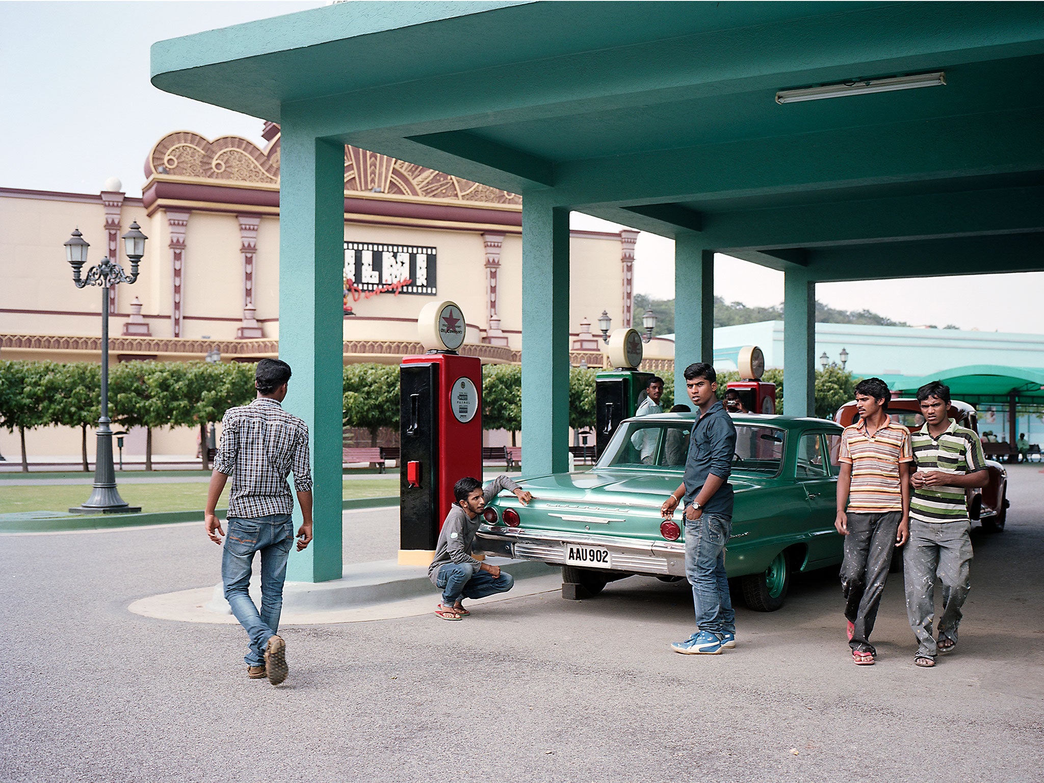 Both car and gas station are part of the film set