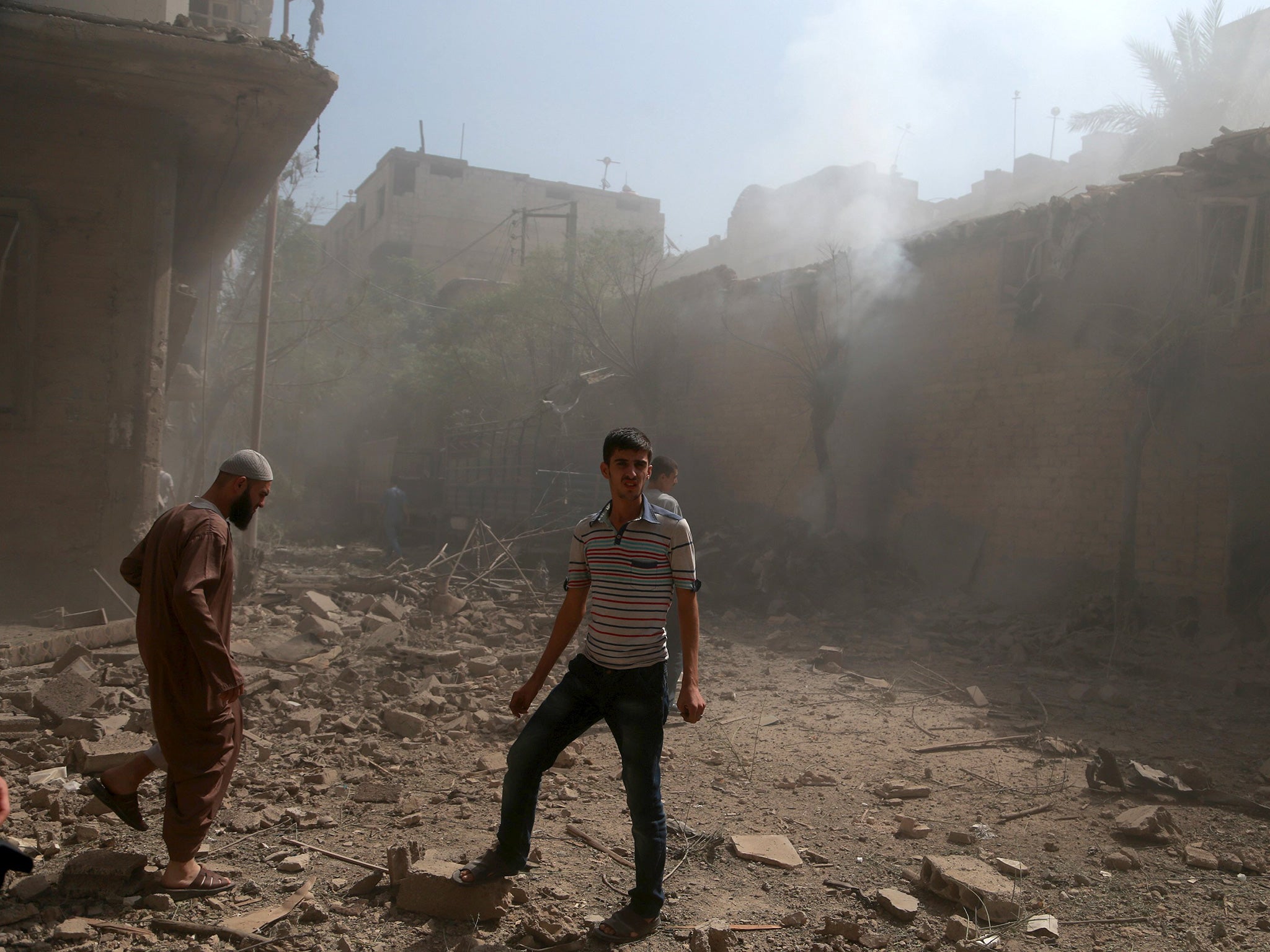 Residents inspect damage from an airstrike