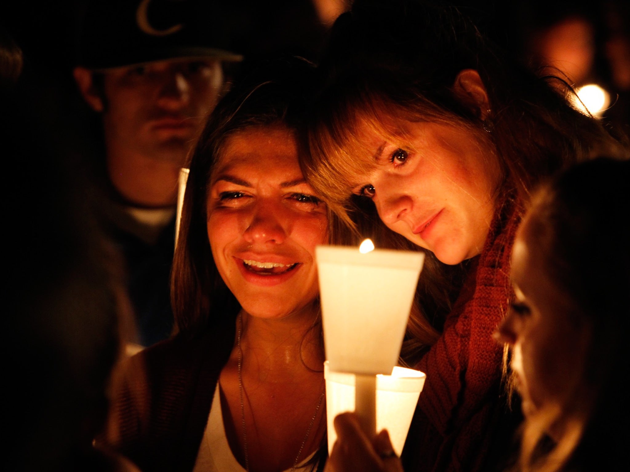 Kristen Sterner and Carrissa Welding, students at Umpqua Community College, embracing during a vigil for those who were killed on Thursday