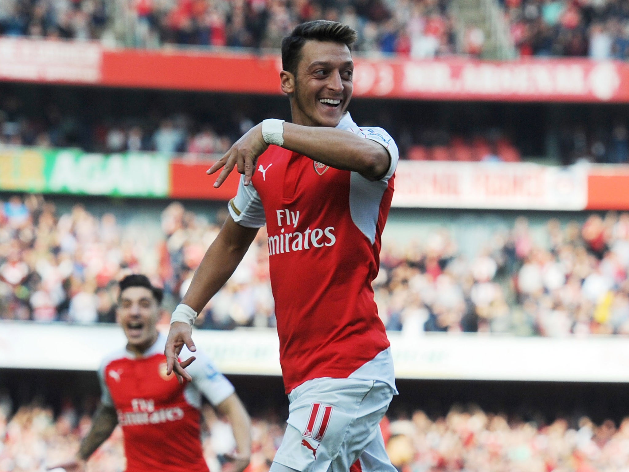 Mesut Ozil celebrates his goal against Manchester United