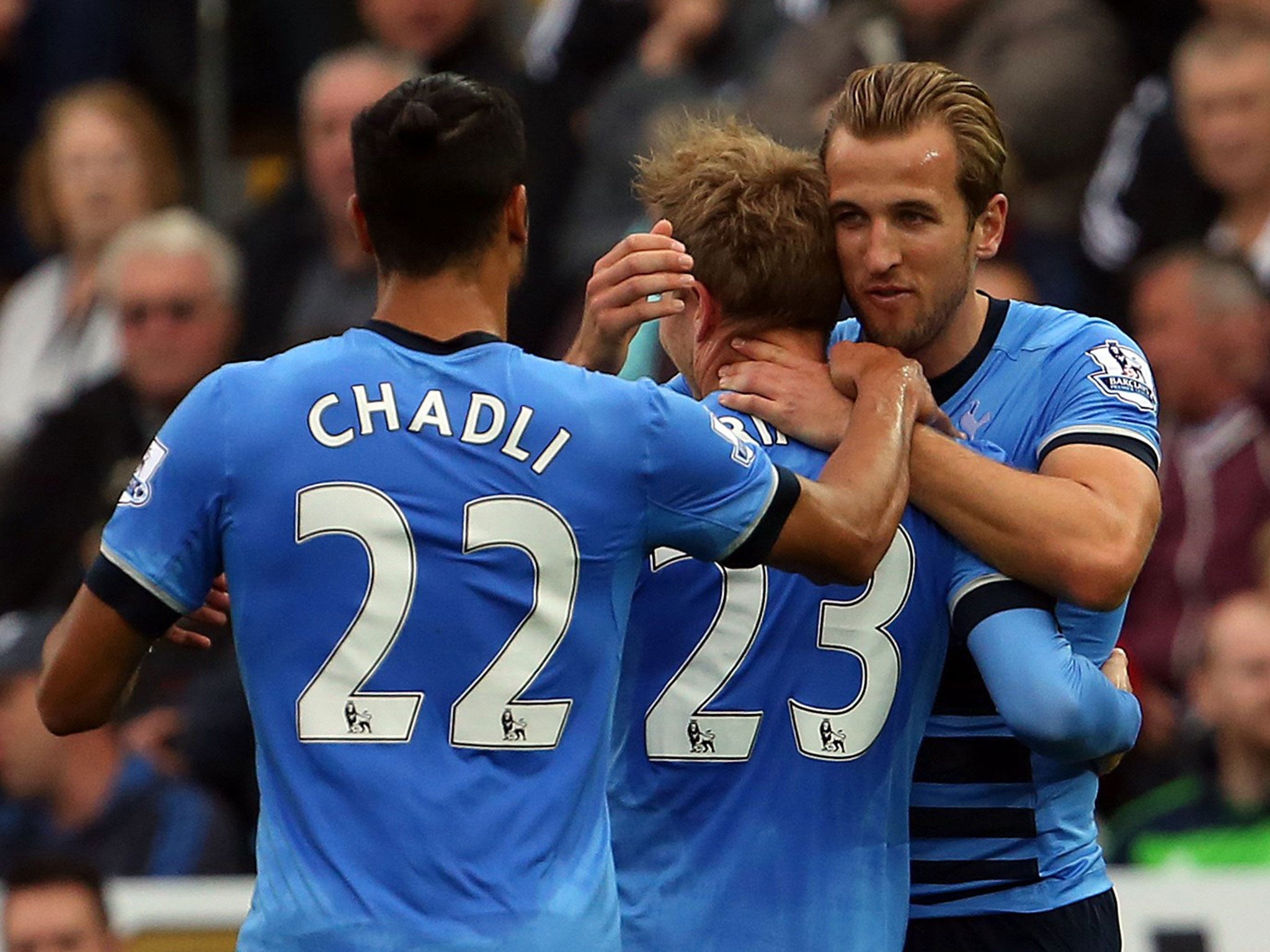 Christian Eriksen celebrates with Harry Kane