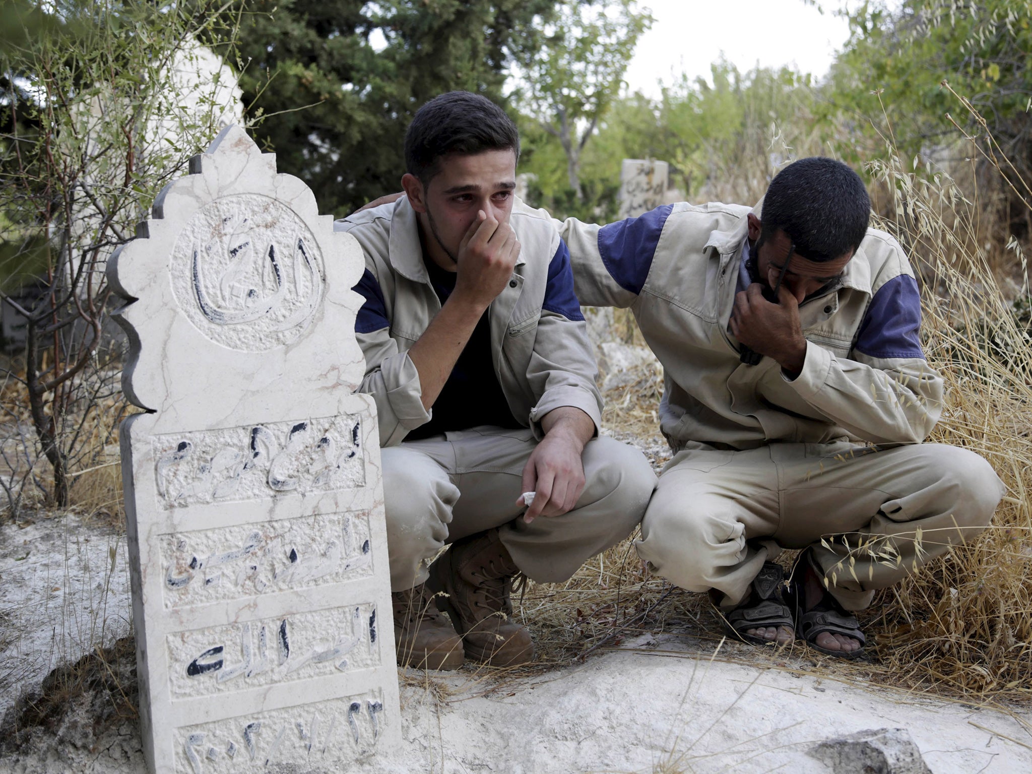 Syrian civil defence members mourn the death of their comrade, who was killed during what rebel activists said were air strikes carried out by the Russian air force