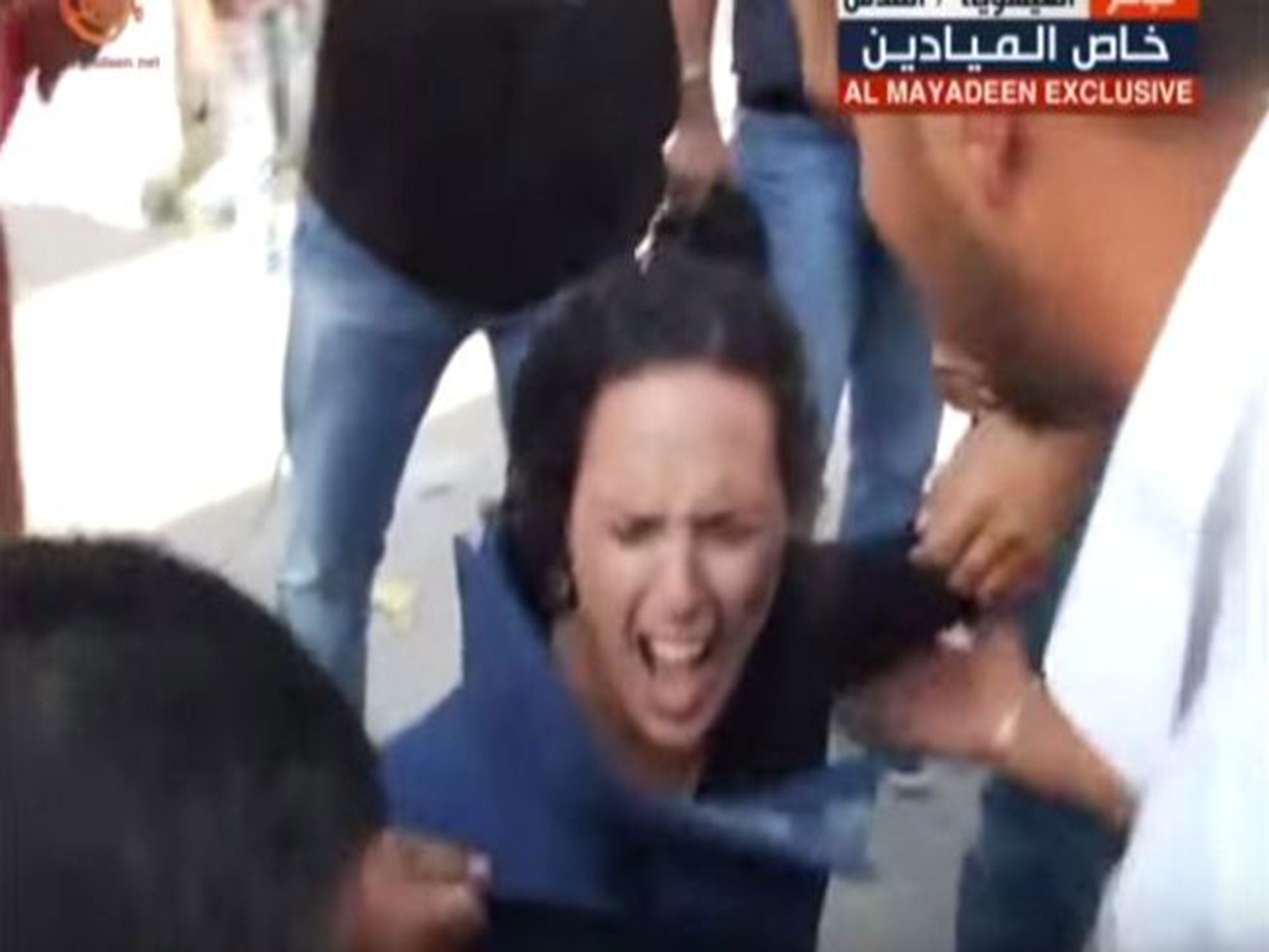 People run to help Al-Mayadeen journalist Hana Mahameed after she is hit by a projectile