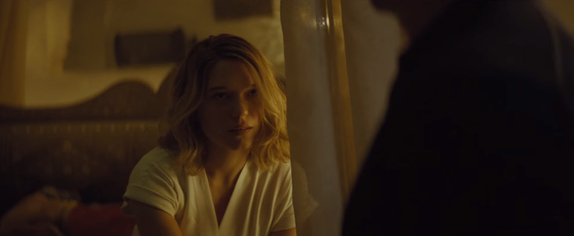 Seydoux looking up at a man from her bed - no prizes for guessing who it is