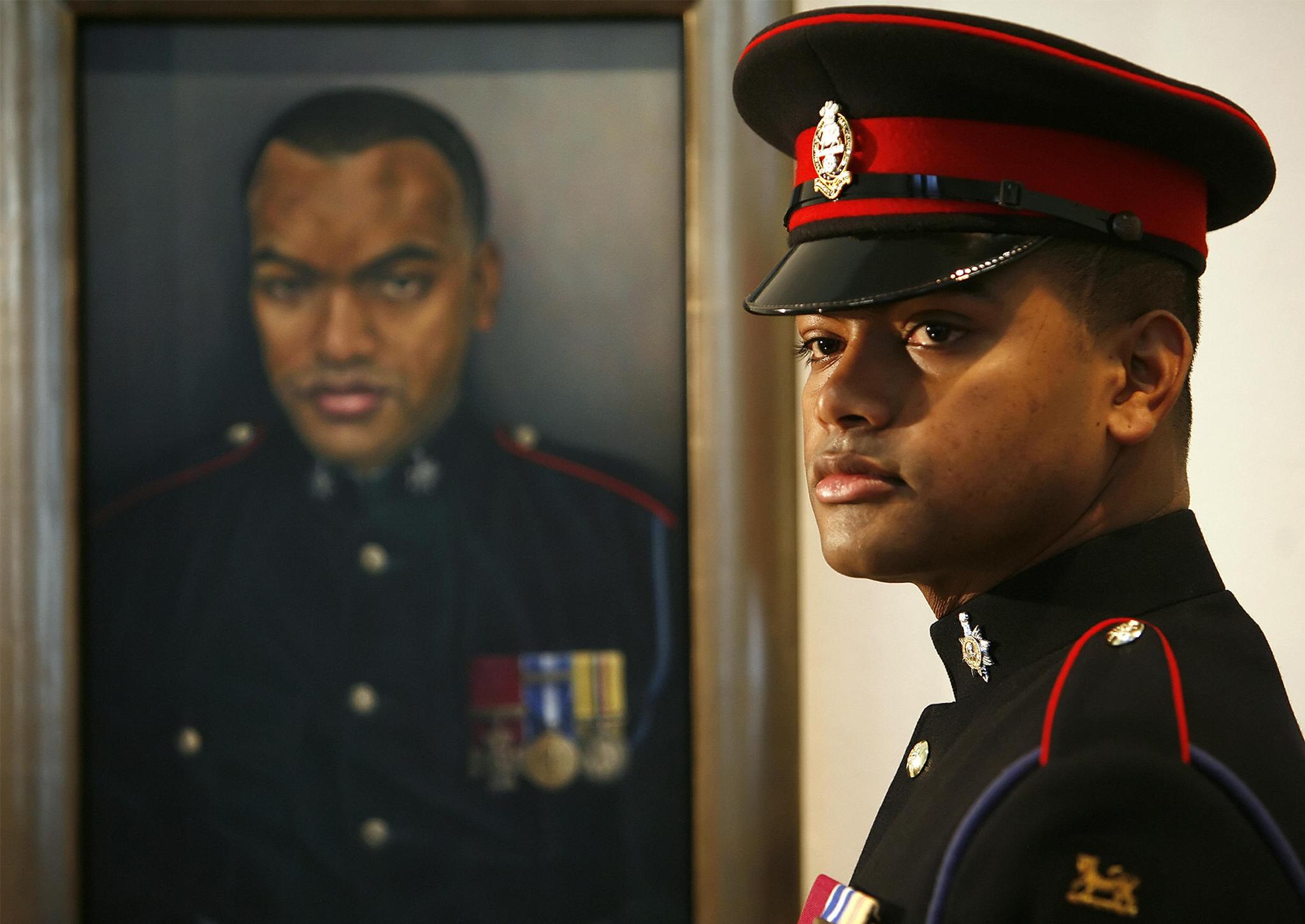 Lance Corporal Johnson Beharry poses for photographs at the unveiling of a new portrait of him at the National Portrait Gallery, London , 21 February 2007