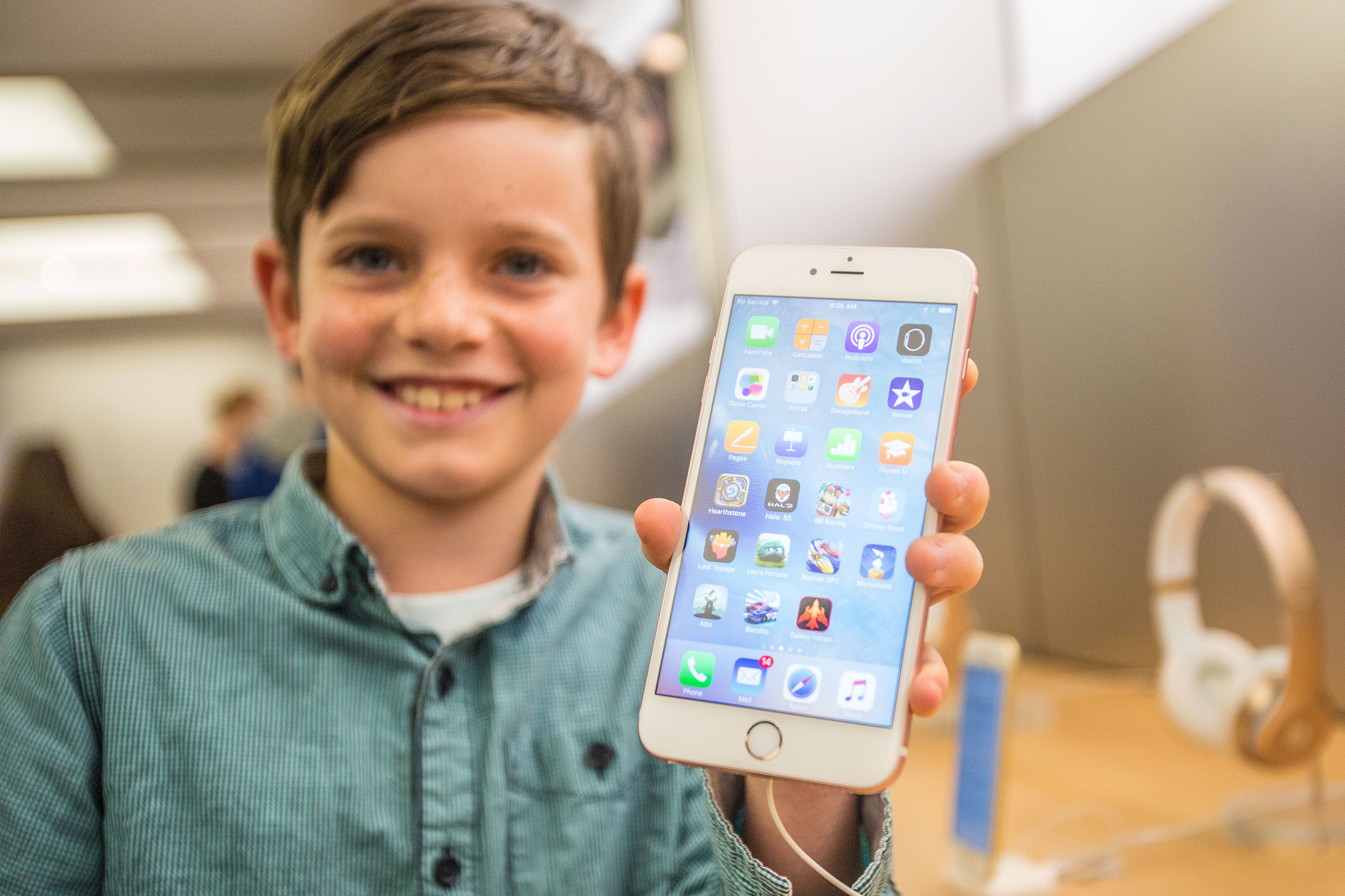 Levi, aged 10, shows off the iPhone 6s on launch day in Sydney, Australia