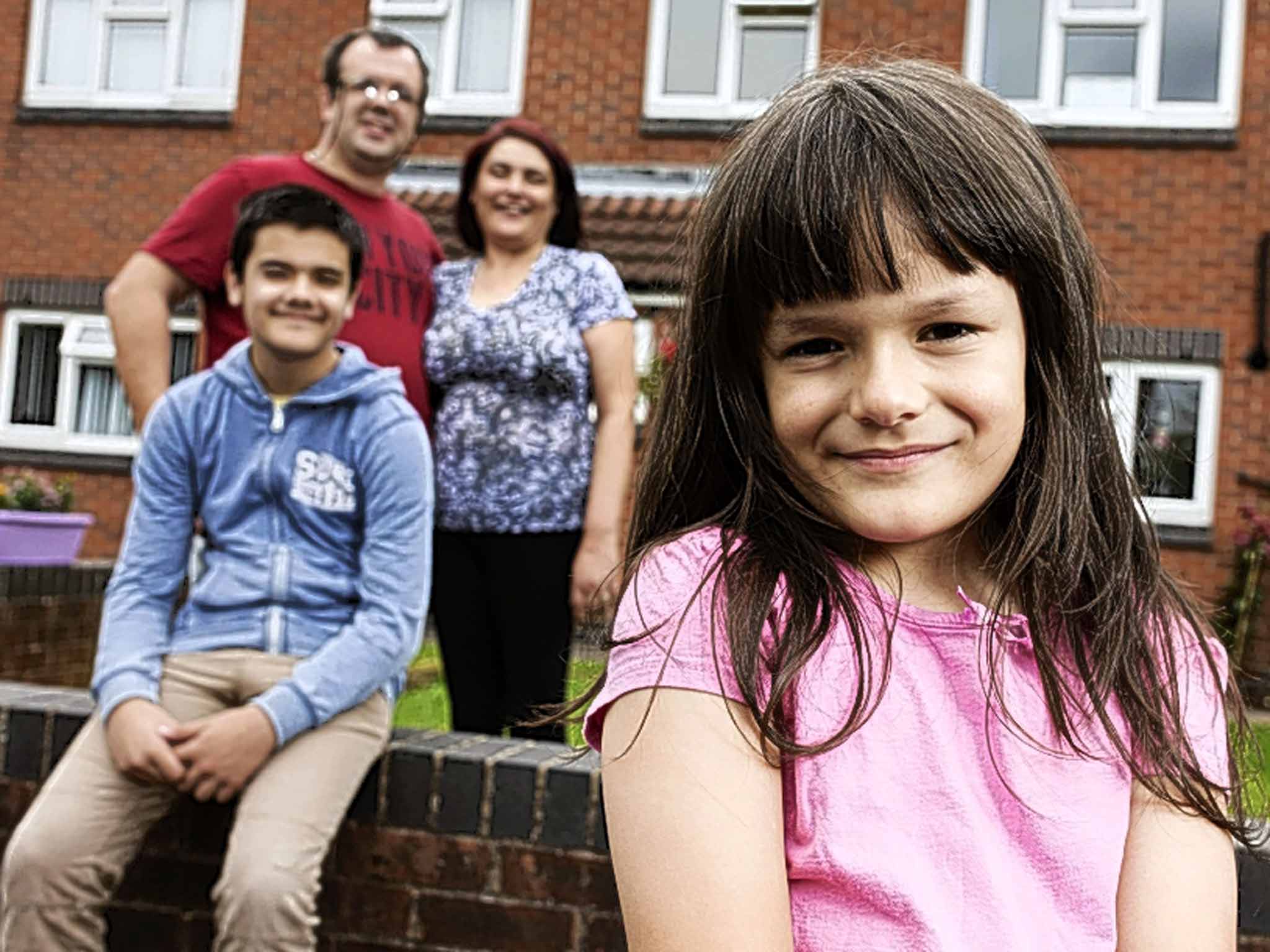 A young person who identifies as the opposite gender to her biological sex, with her family at home