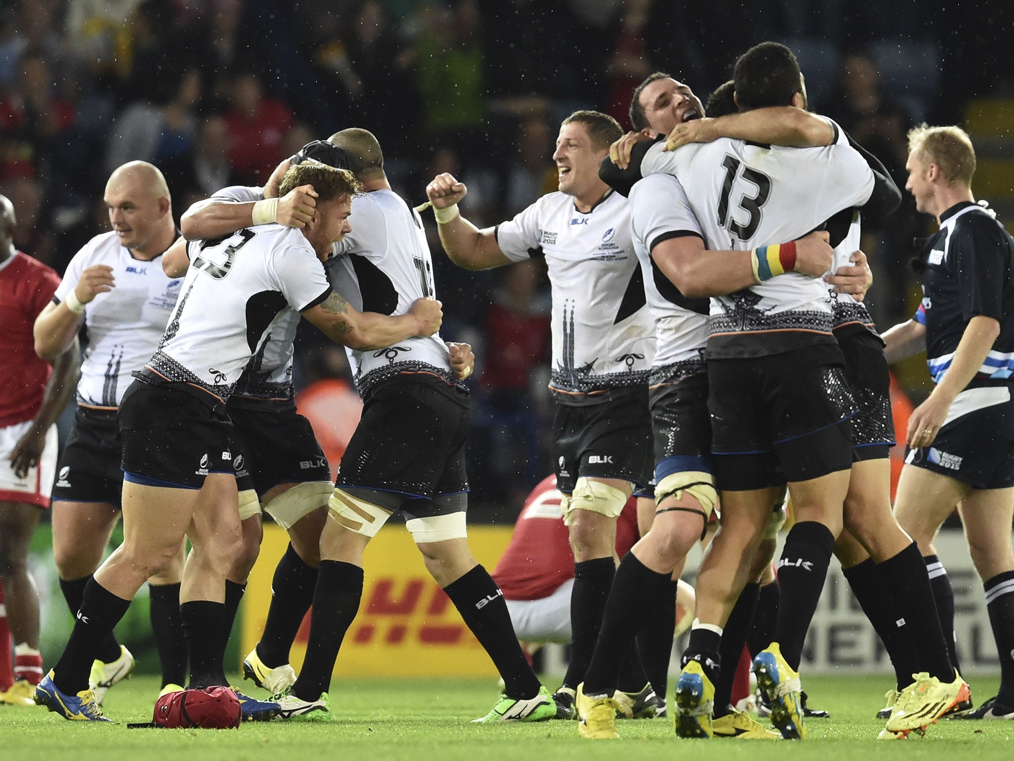 Romania celebrate their comeback victory over Canada