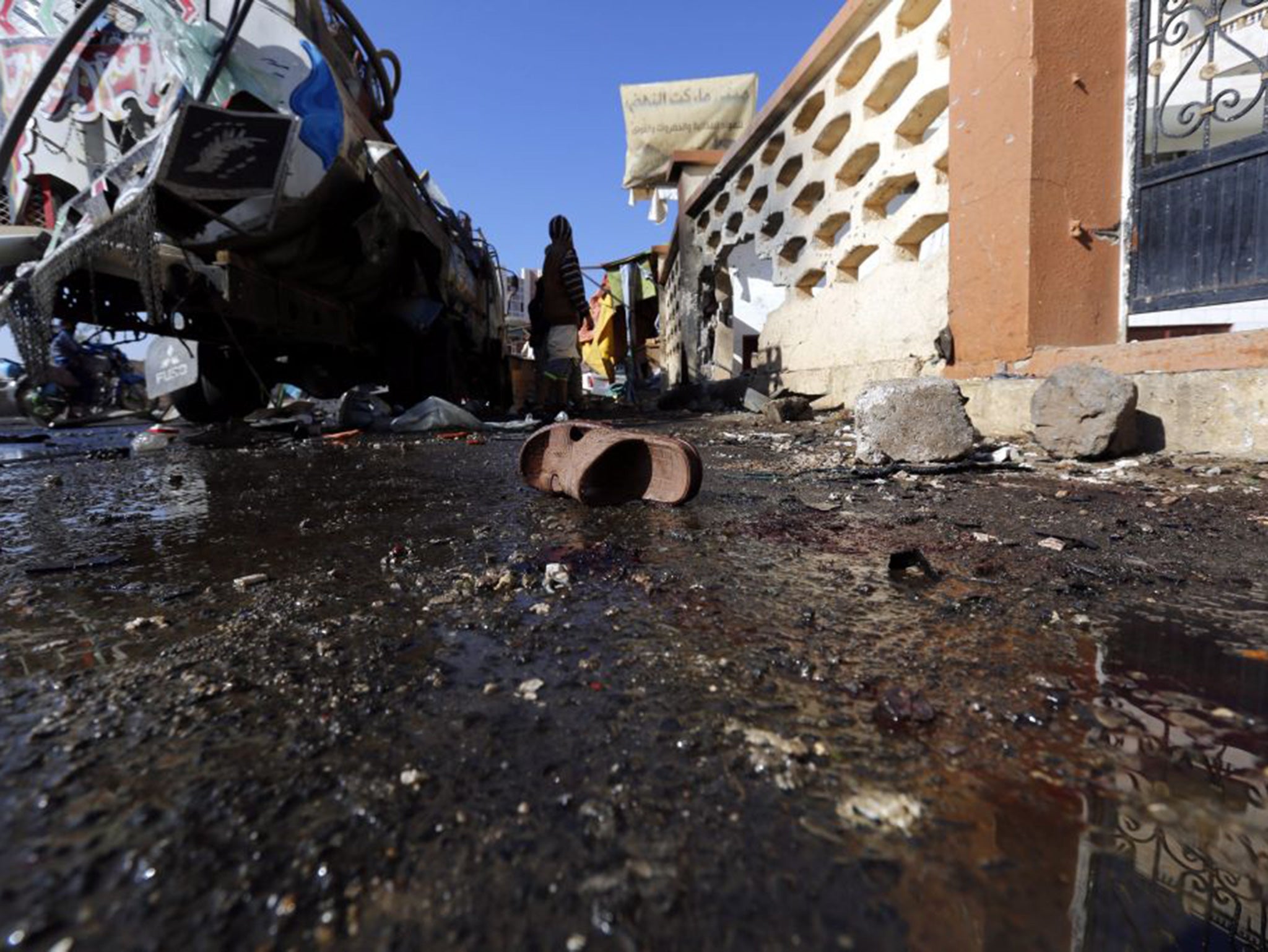 A sandle sits at the site of a suicide attack in Sanaa on 7 October