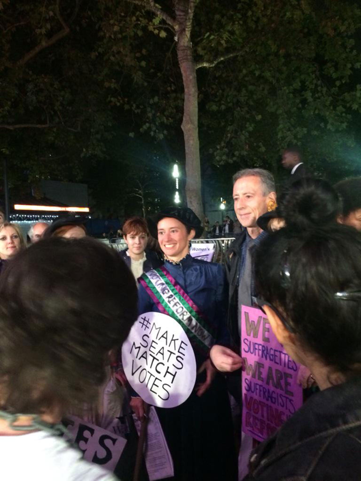 A protester dressed as suffragette at the premiere