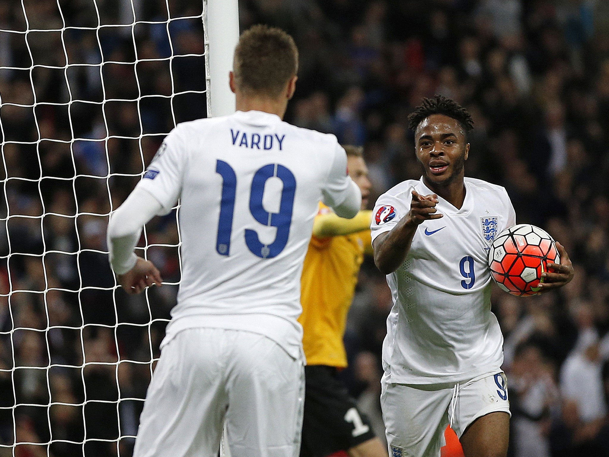 Raheem Sterling celebrates with Jamie Vardy after scoring for England against Estonia