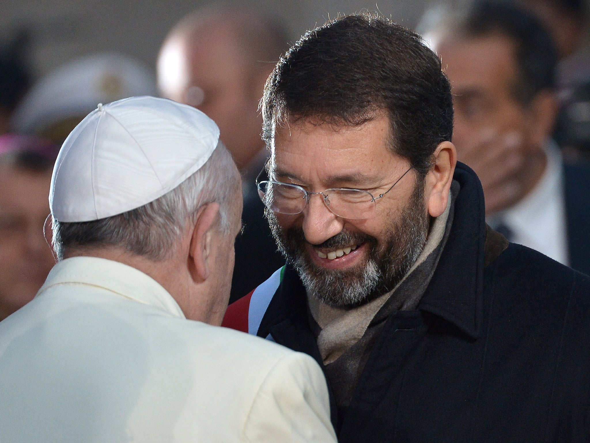 Pope Francis speaks with Rome's mayor Ignazio Marino after a prayer at the statue of Virgin Mary