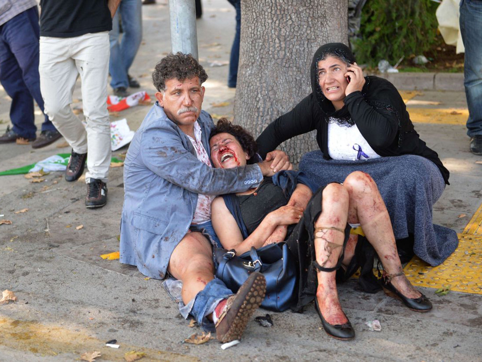 The wounded are comforted in the aftermath of the blast