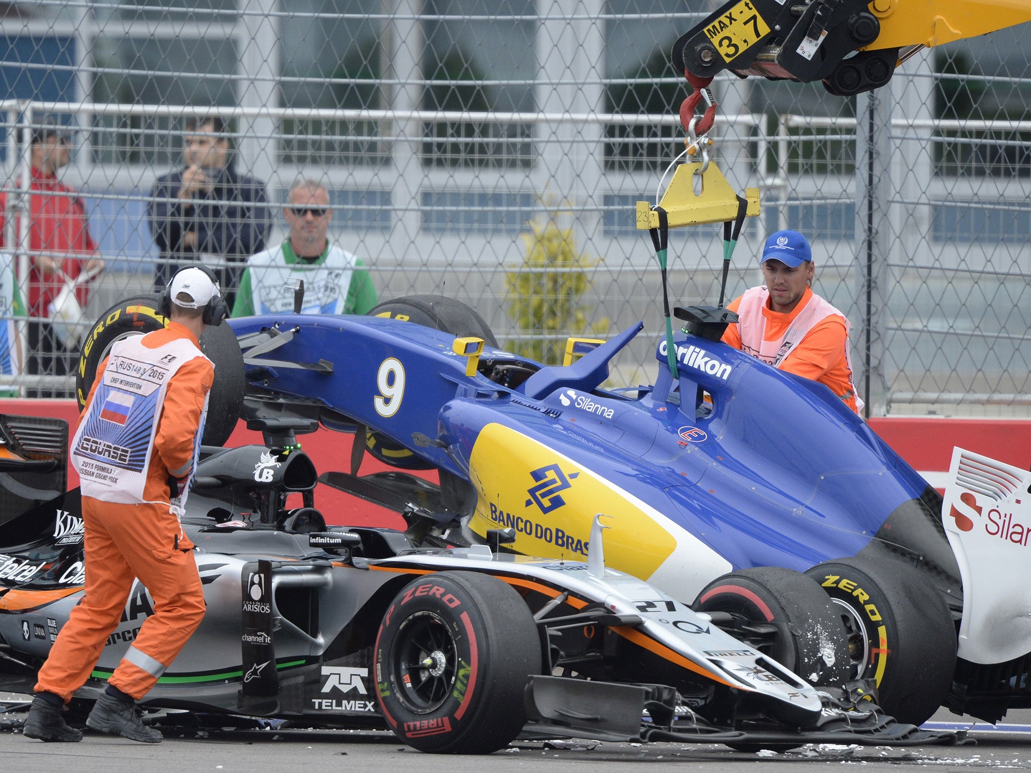 Marcus Ericcson's Sauber is park on top of Nico Hulkenberg's Force India