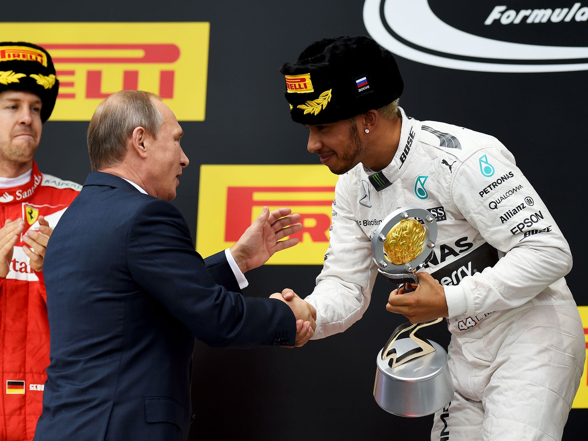 Russian president Vladimir Putin congratulates Lewis Hamilton after he wins the Russian Grand Prix