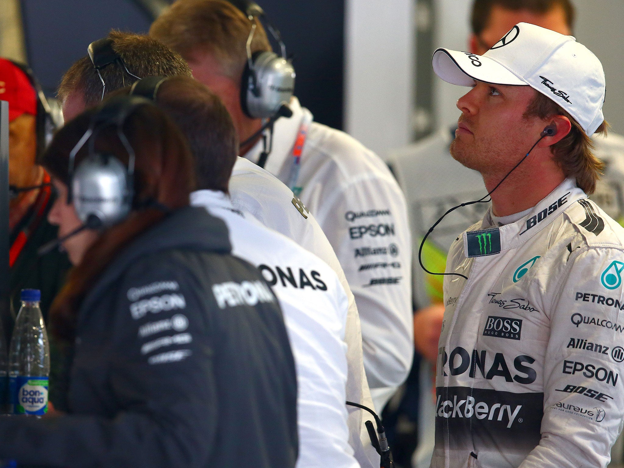 A disappointed Nico Rosberg watches the race from the pits after retiring