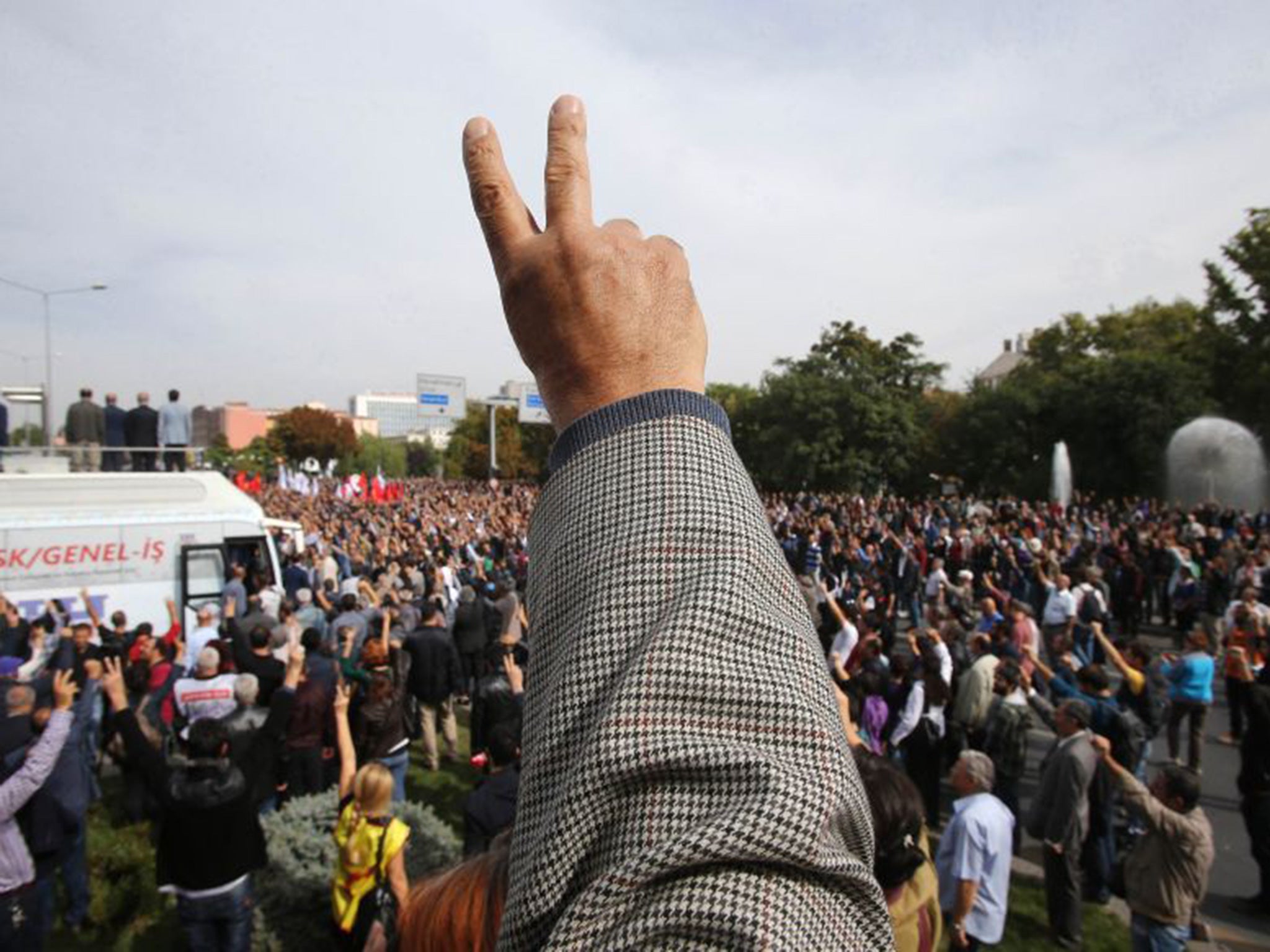 A man flashes the victory sign during a rally on Sihhiye Square