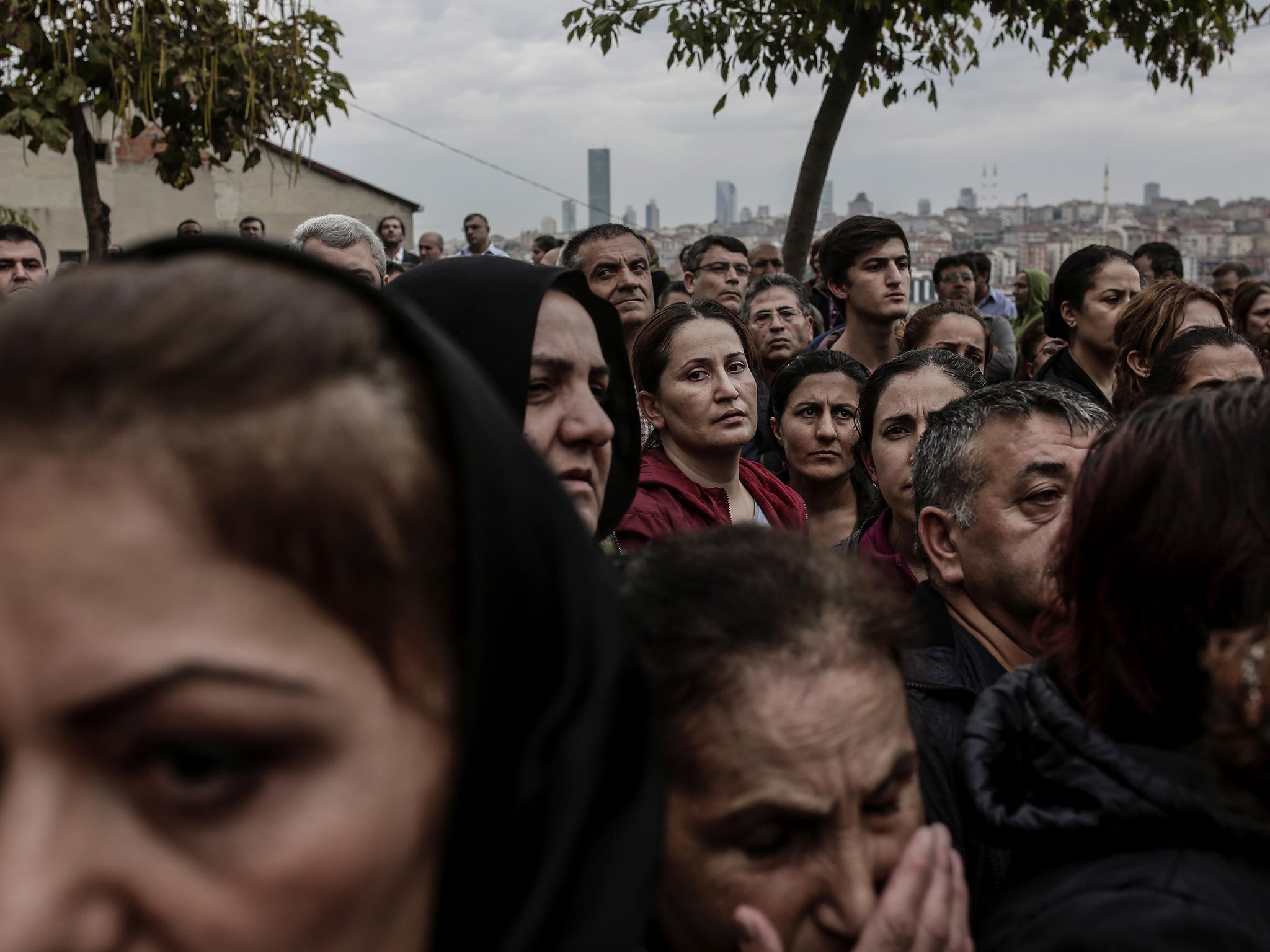 Relatives mourn near the coffin of a victim of the twin bombings