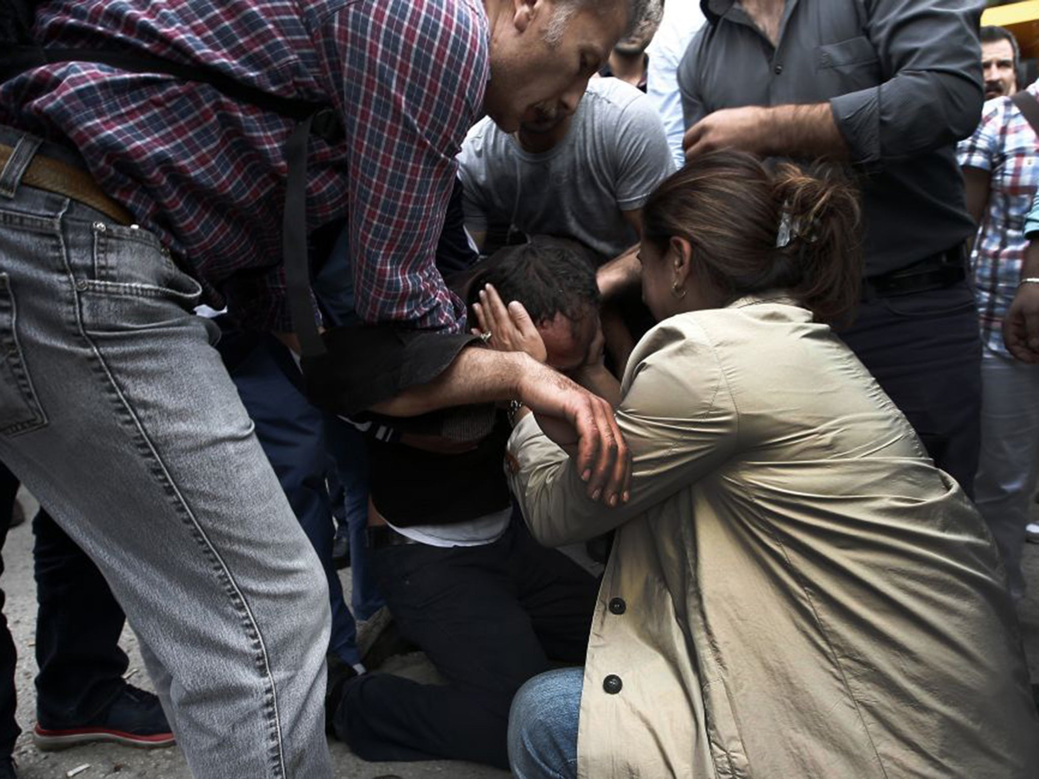 A relative of a victim of Saturday's bombing attack reacts, outside a hospital's morgue