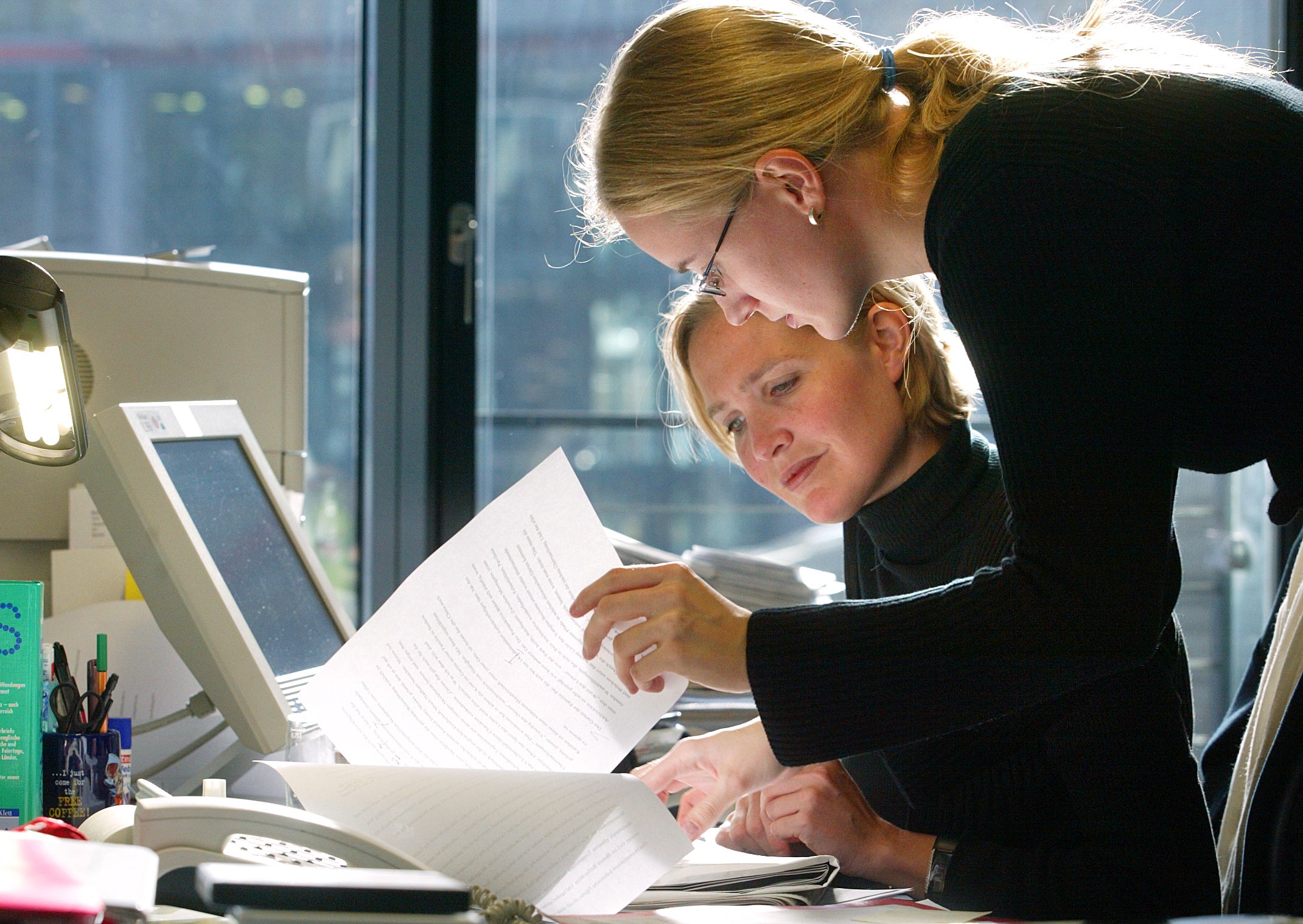 Women employees work at a desk