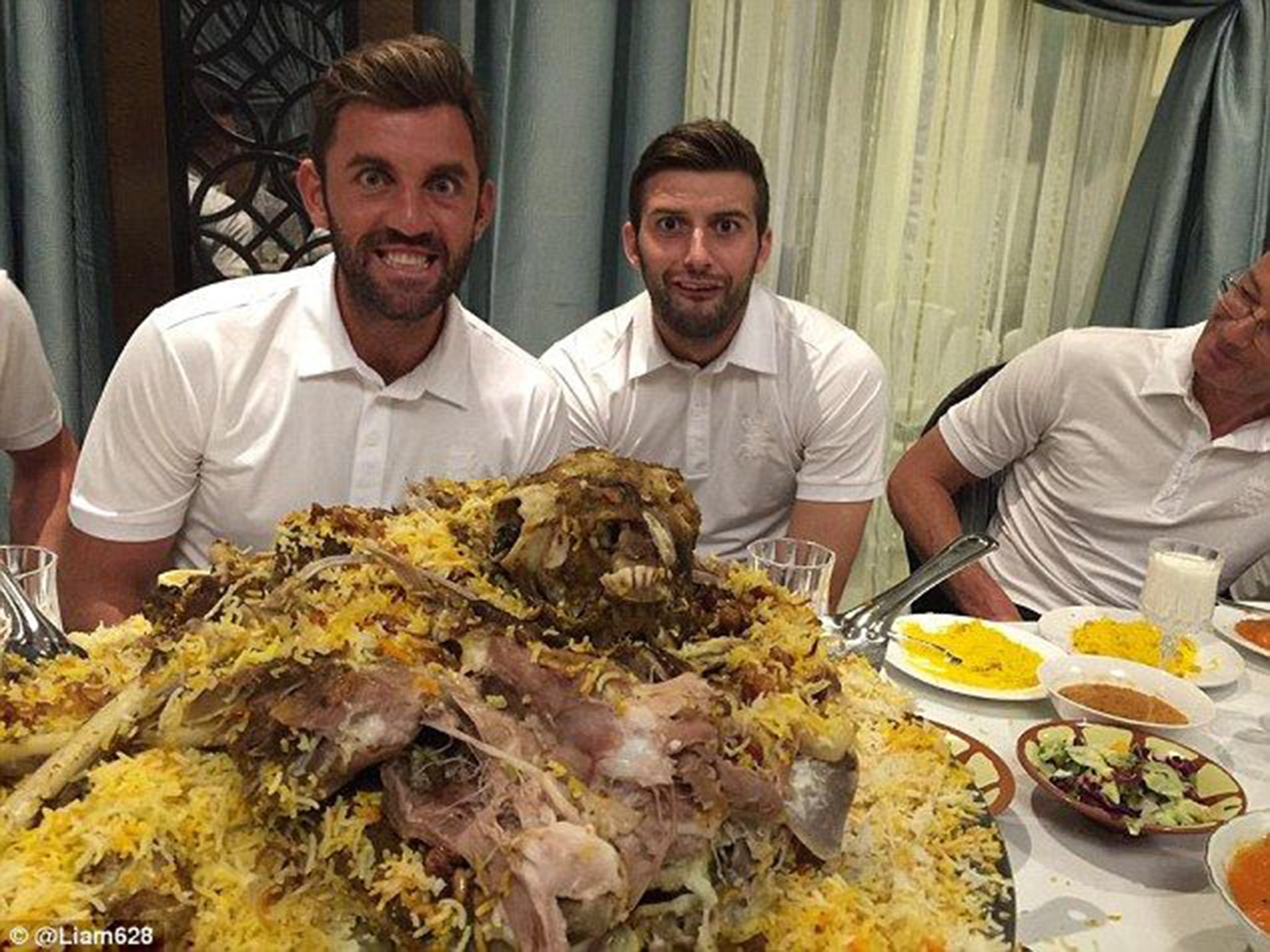 Liam Plunkett, left, and Mark Wood come face to face with an alternative roast lunch of goat before taking on Pakistan in the first Test
