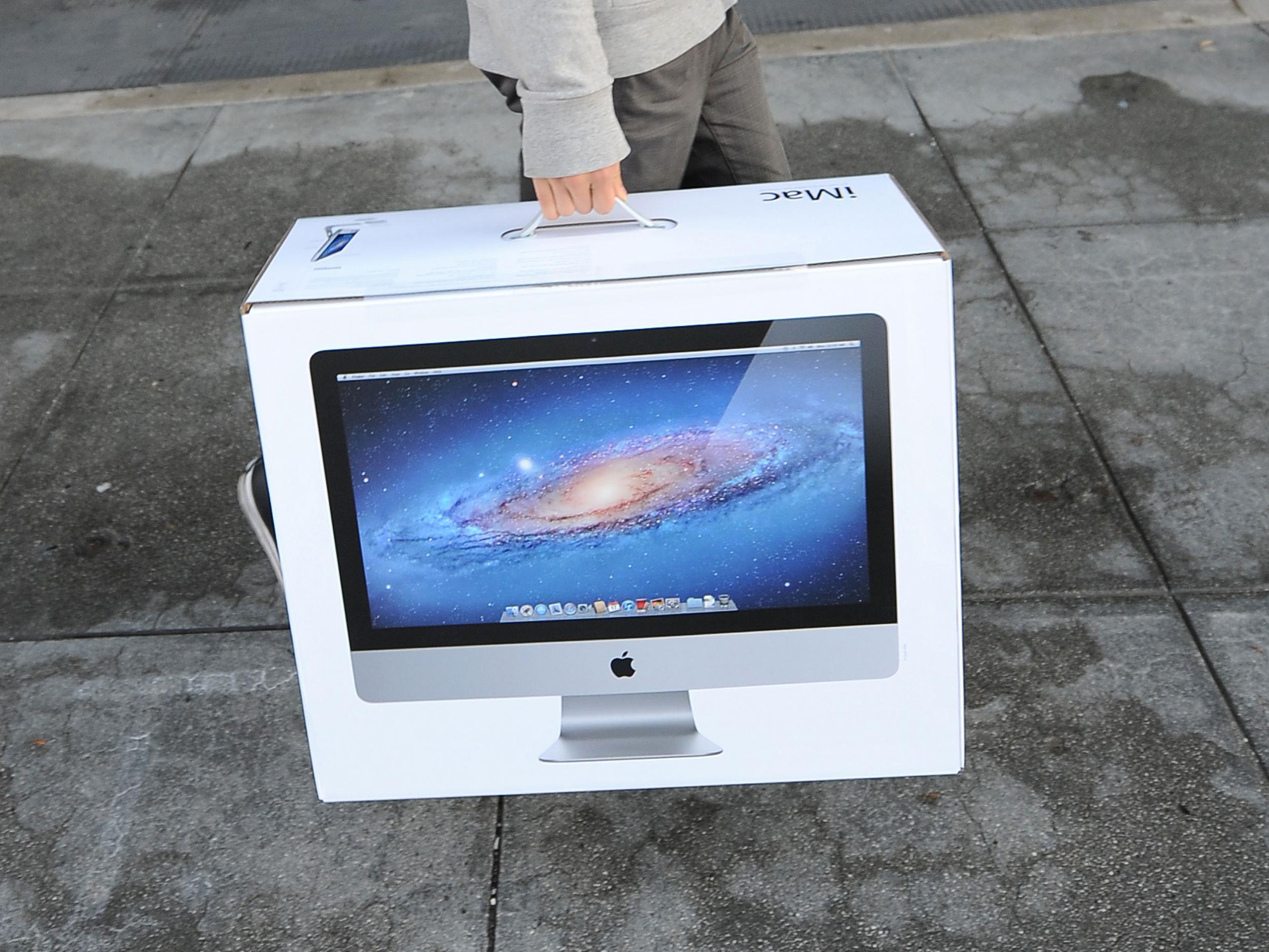 Jason Chen leaves the Apple store in Pasadena, California with a new iMac computer October 5, 2011