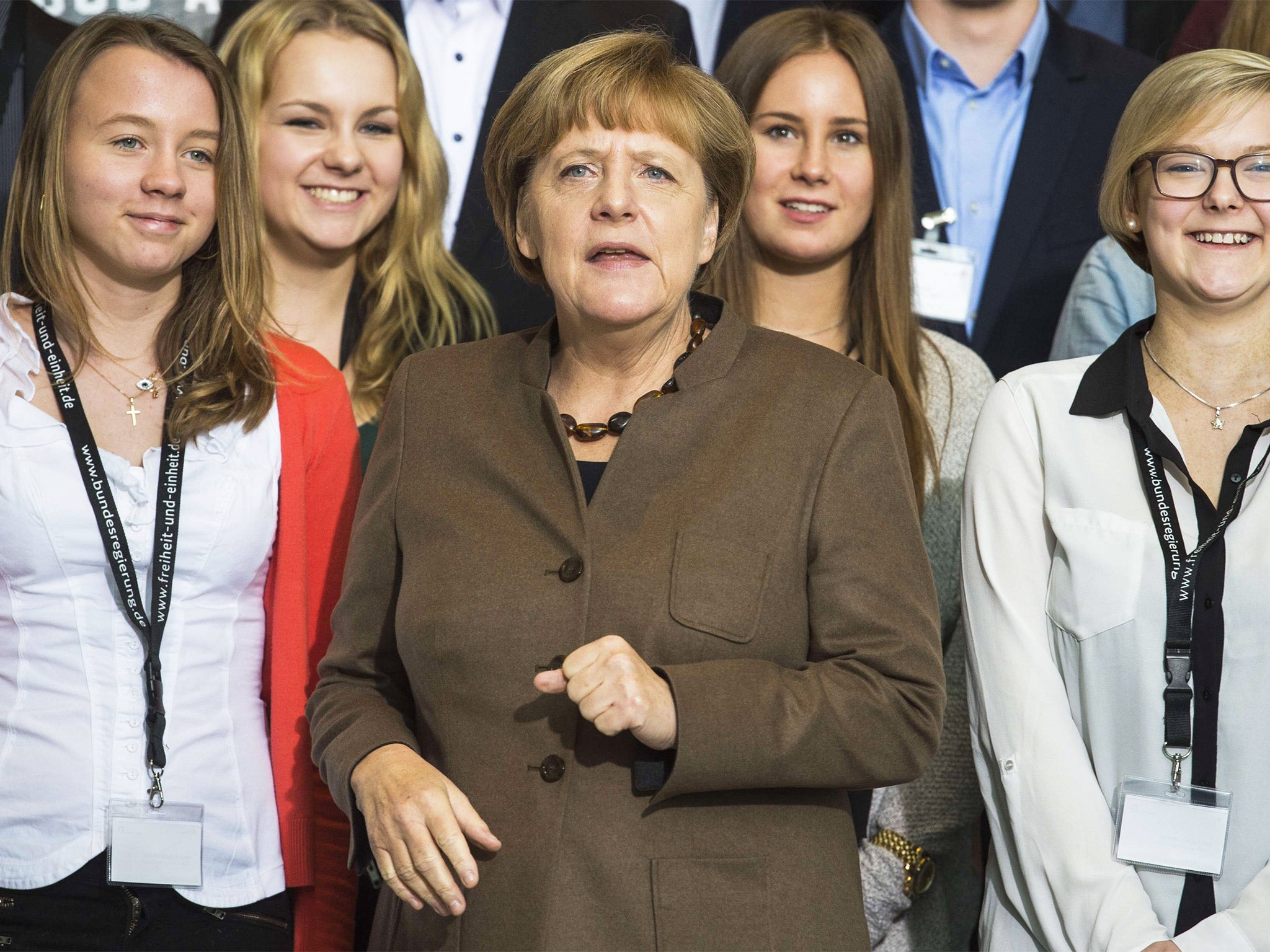 &#13;
Angela Merkel, with students in Berlin on Tuesday, has admitted her ‘transit zone’ plan would not work for thousands of refugees (Getty)&#13;