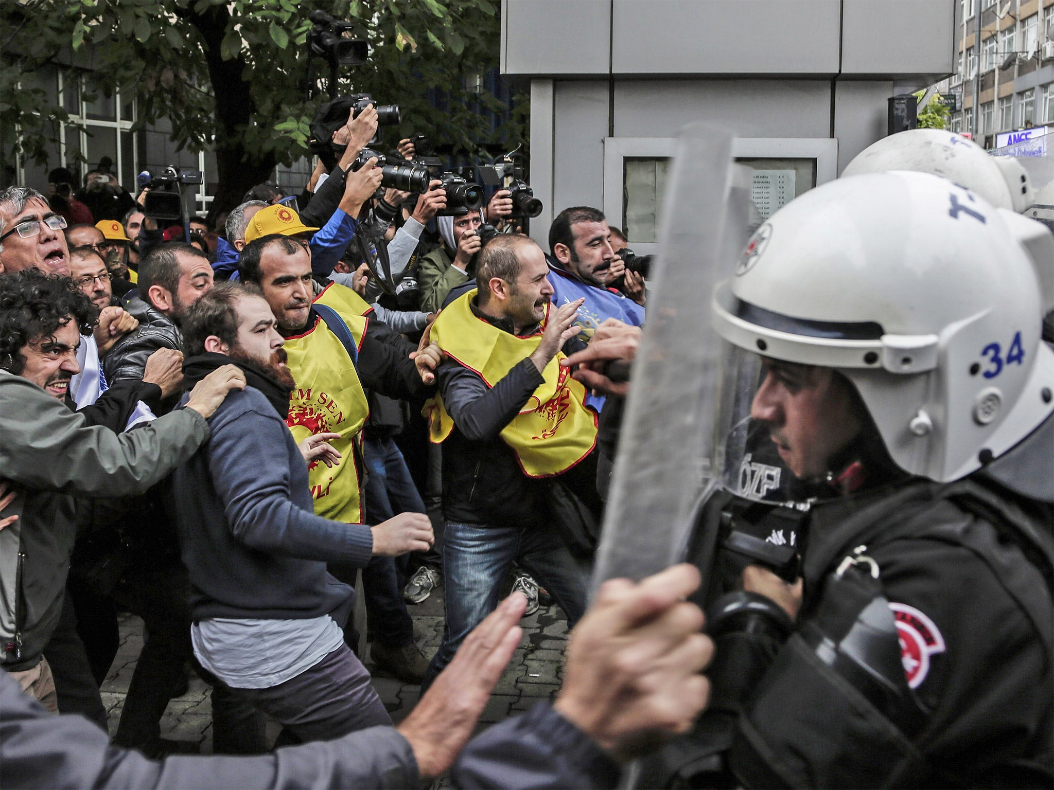 Protesters clash with Turkish riot police during a demonstration in Istanbul against the deadly attacks in Ankara