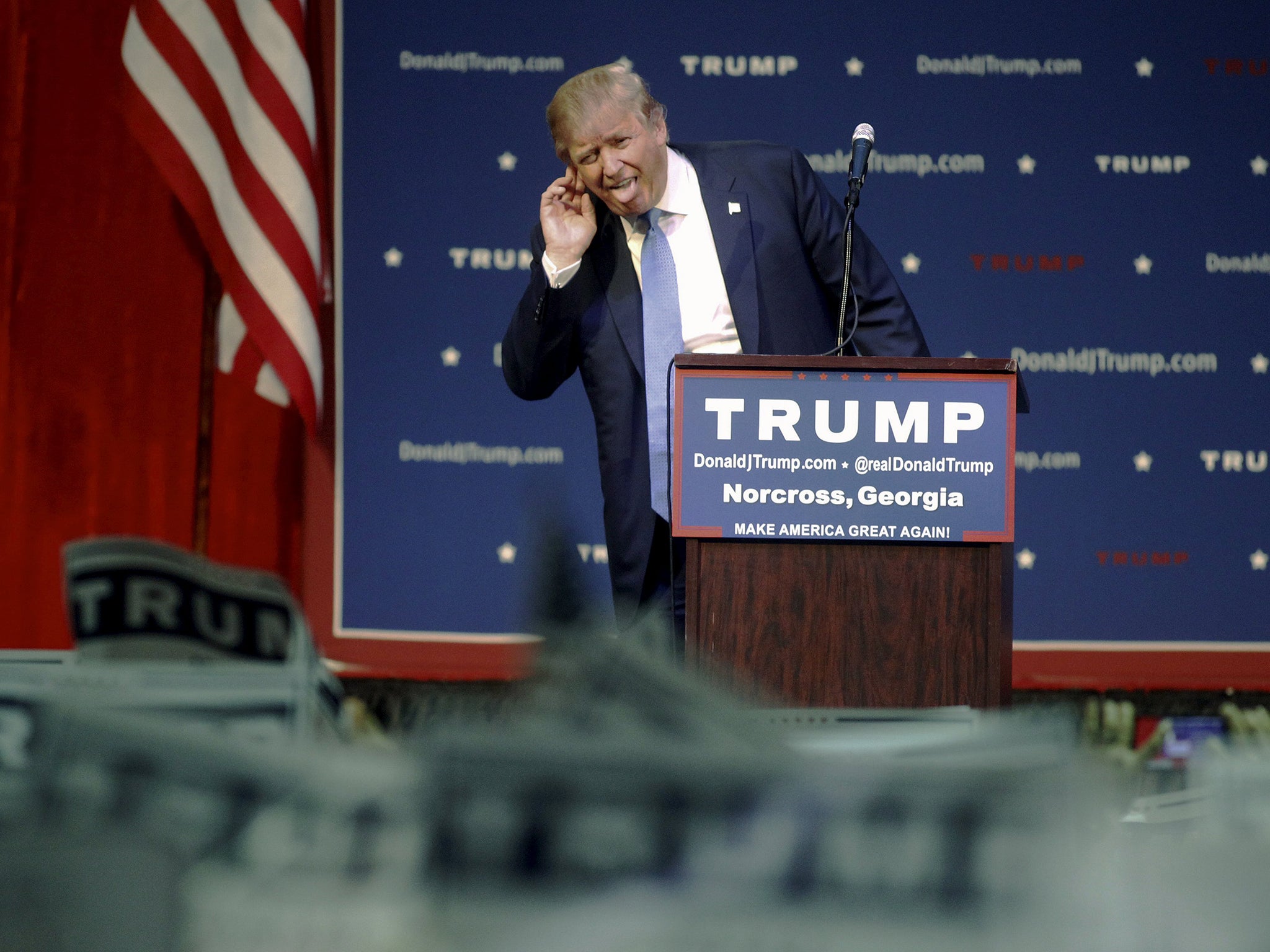 U.S. Republican presidential candidate Donald Trump reacts as he arrives at a rally in Norcross, Georgia