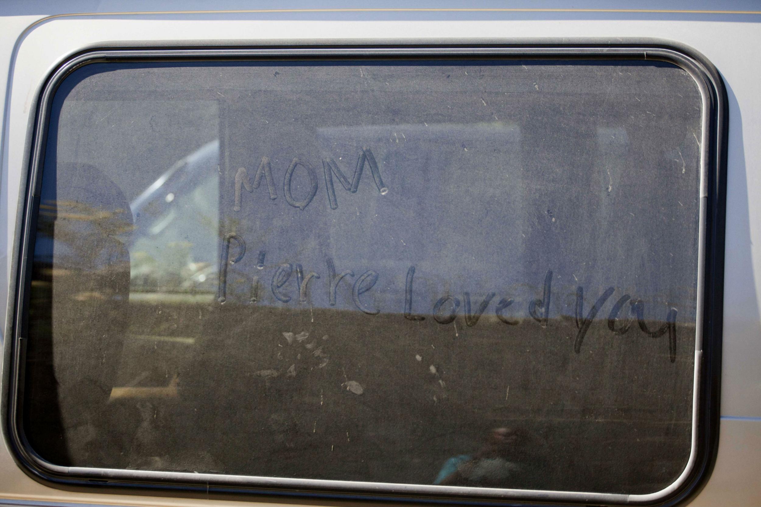 A message traced in the dust of a car outside the Sonlight Children's Home in the Port-au-Prince