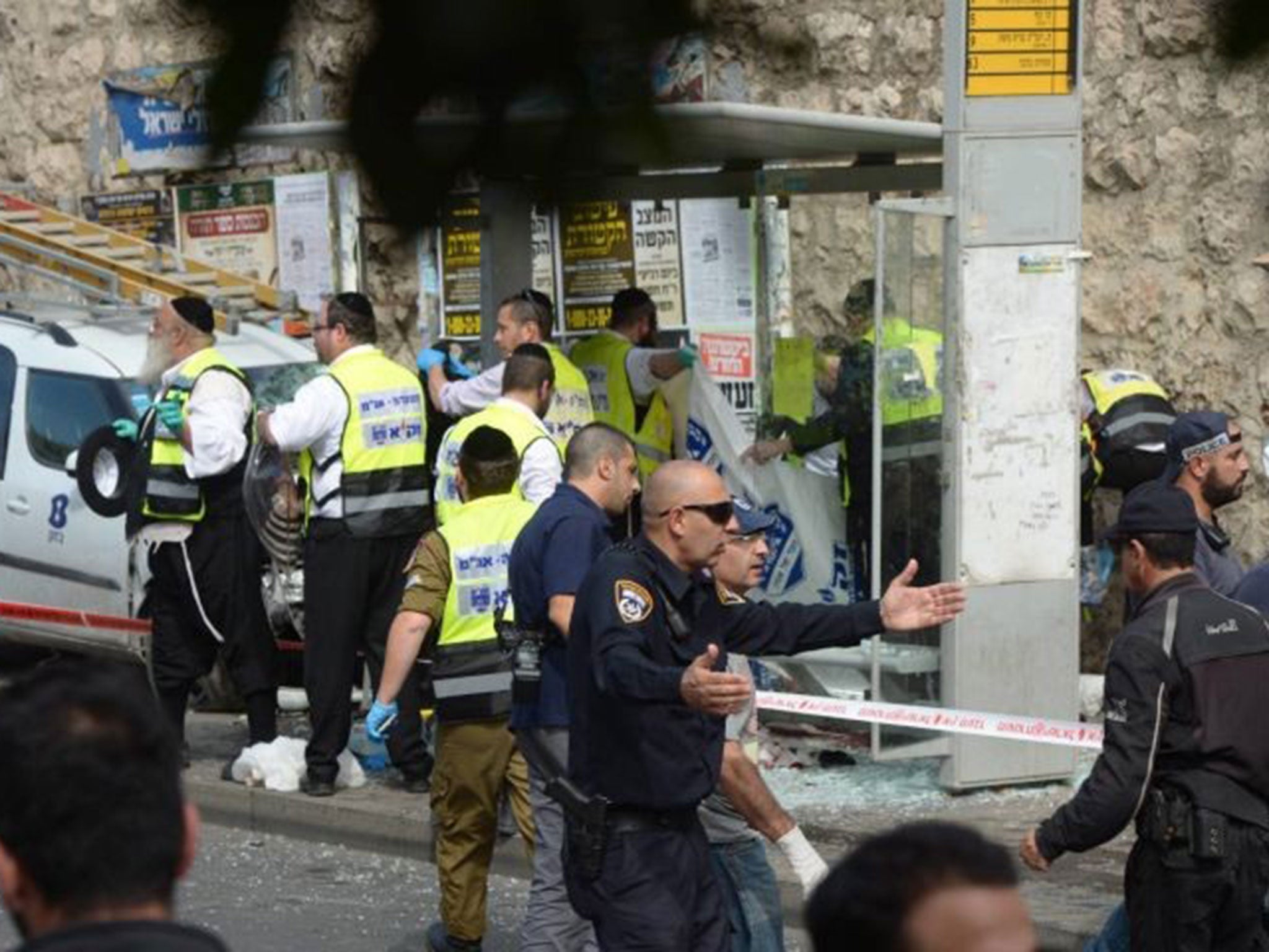 Israeli emergency personnel working at the scene of an attack in Malchei Israel Street, Jerusalem, Israel, 13 October 2015