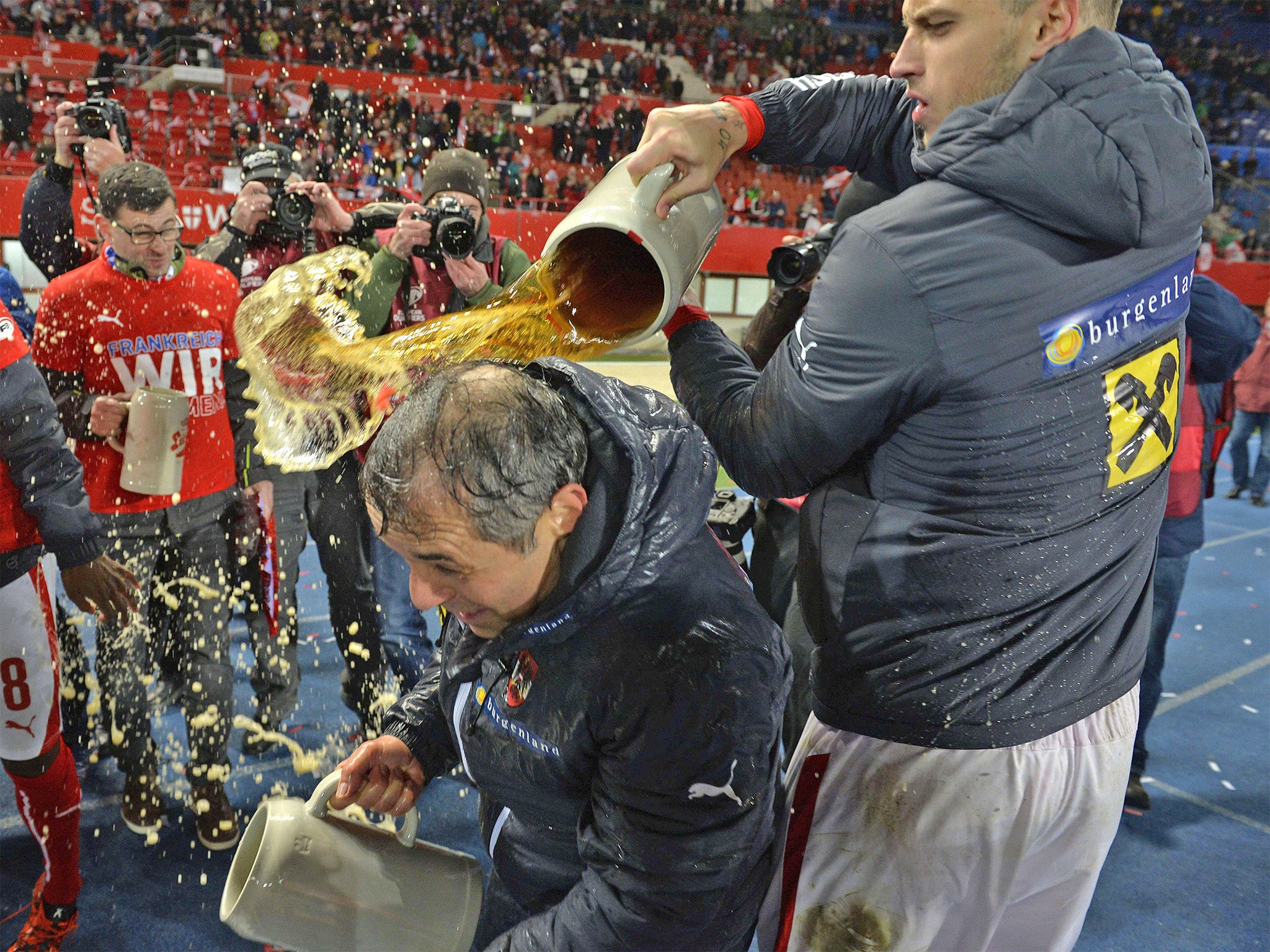 &#13;
Austria's Marko Arnautovic soaks head coach Marcel Koller with some locally brewed lager (Getty)&#13;