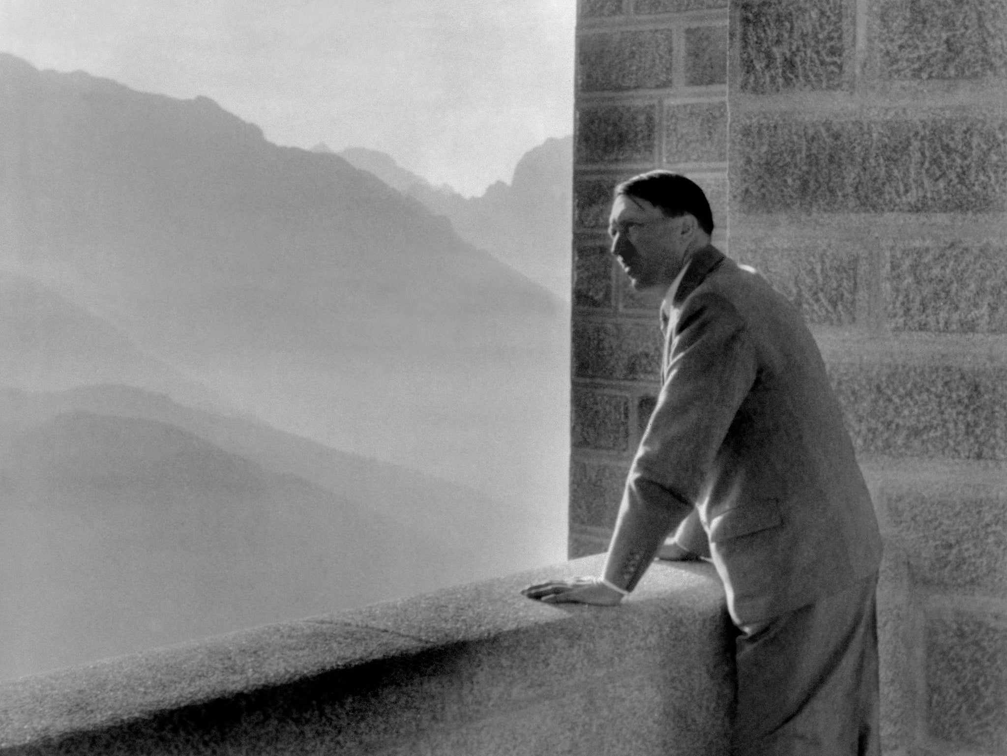 A picture dated 1938 shows German nazi Chancellor Adolf Hitler looking at the Obersalzberg Mountains from a balcony of his Berghof residence near Berchtesgaden