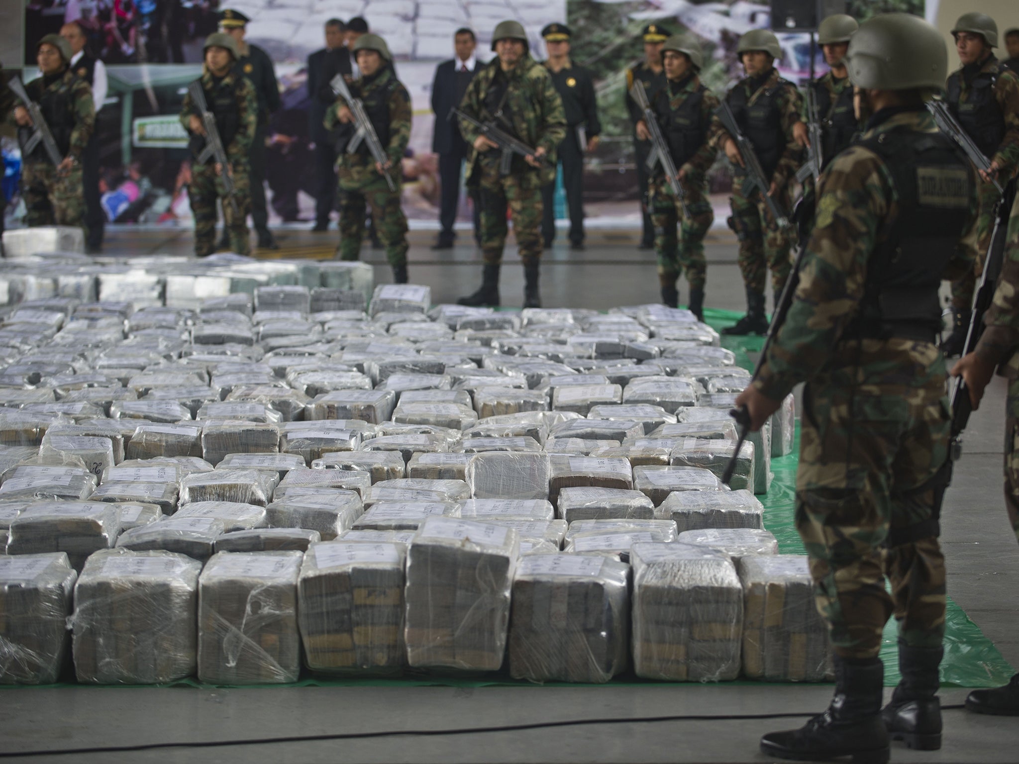 Police officers stand guard over a 7-tonne haul of cocaine seized at the Jorge Chávez International Airport in Lima in 2014