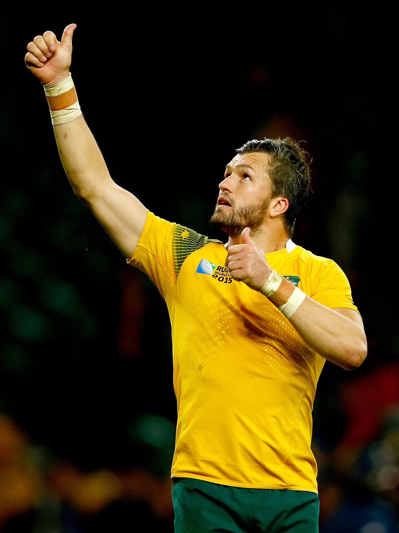 Australia's Adam Ashley-Cooper gestures to his friend, Guy Grinham, after the win over Wales