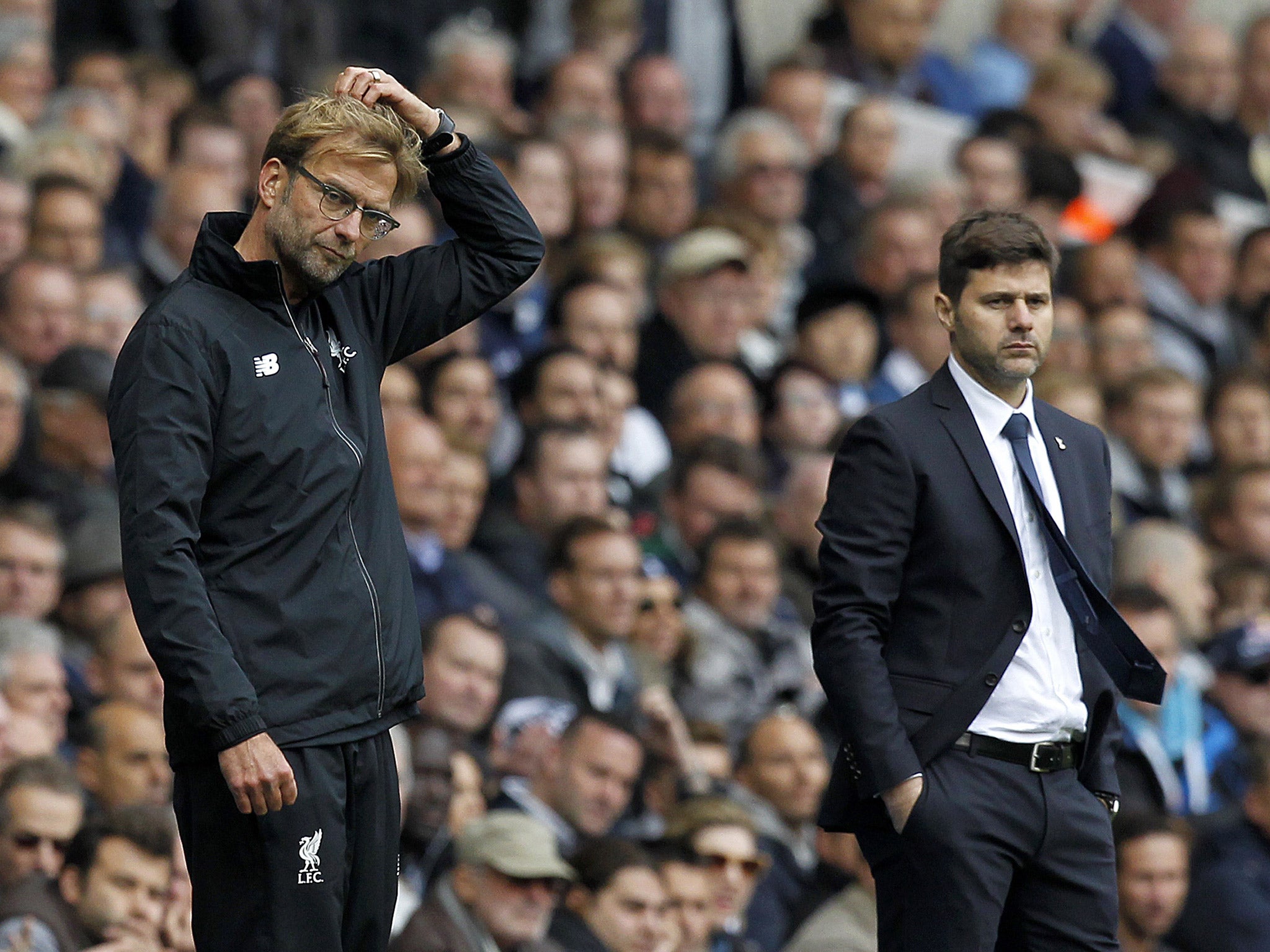 Jurgen Klopp and Mauricio Pochettino watch their teams from the sidelines