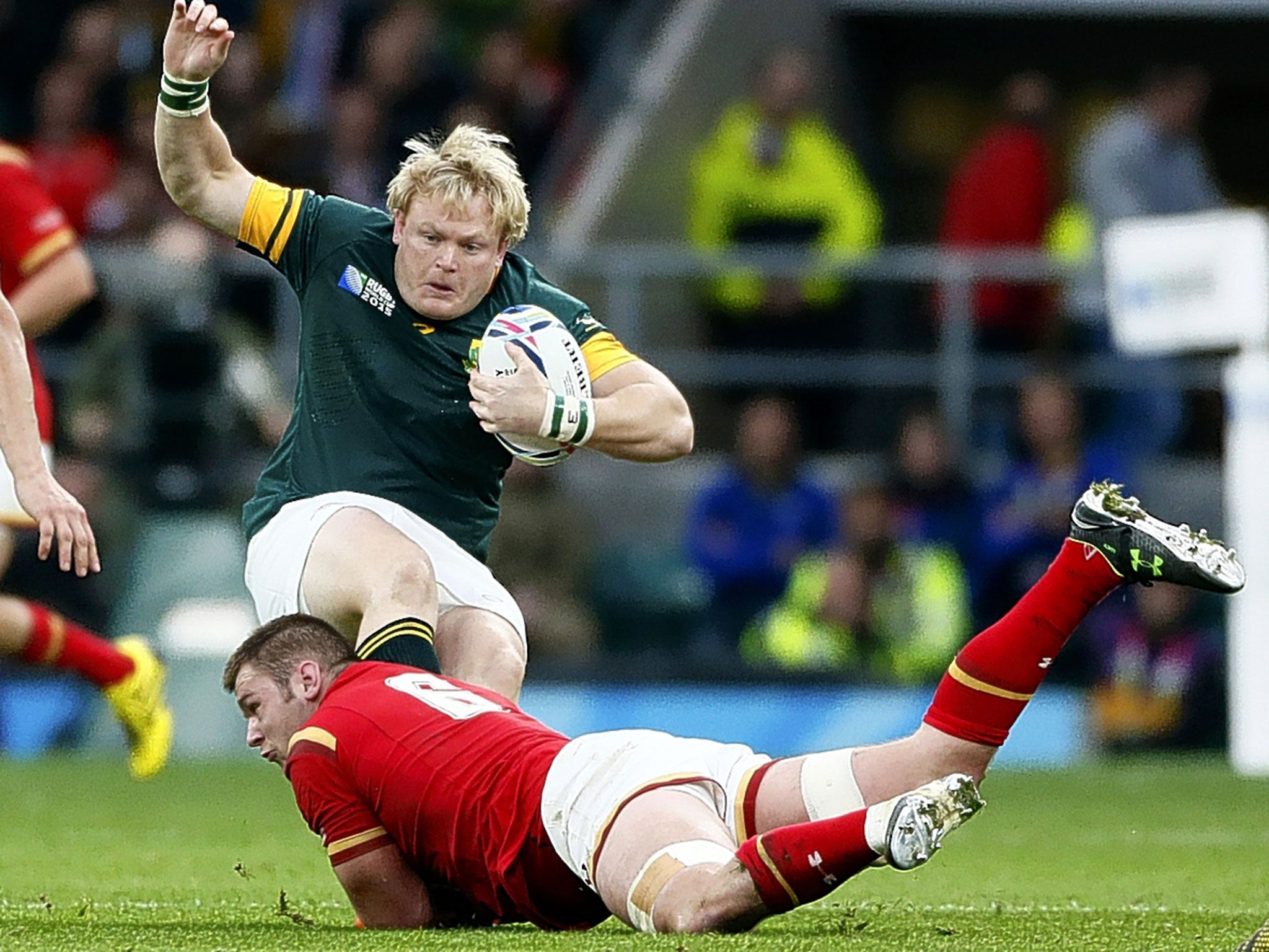 Dan Lydiate, of Wales, tackles South Africa’s Adriaan Strauss