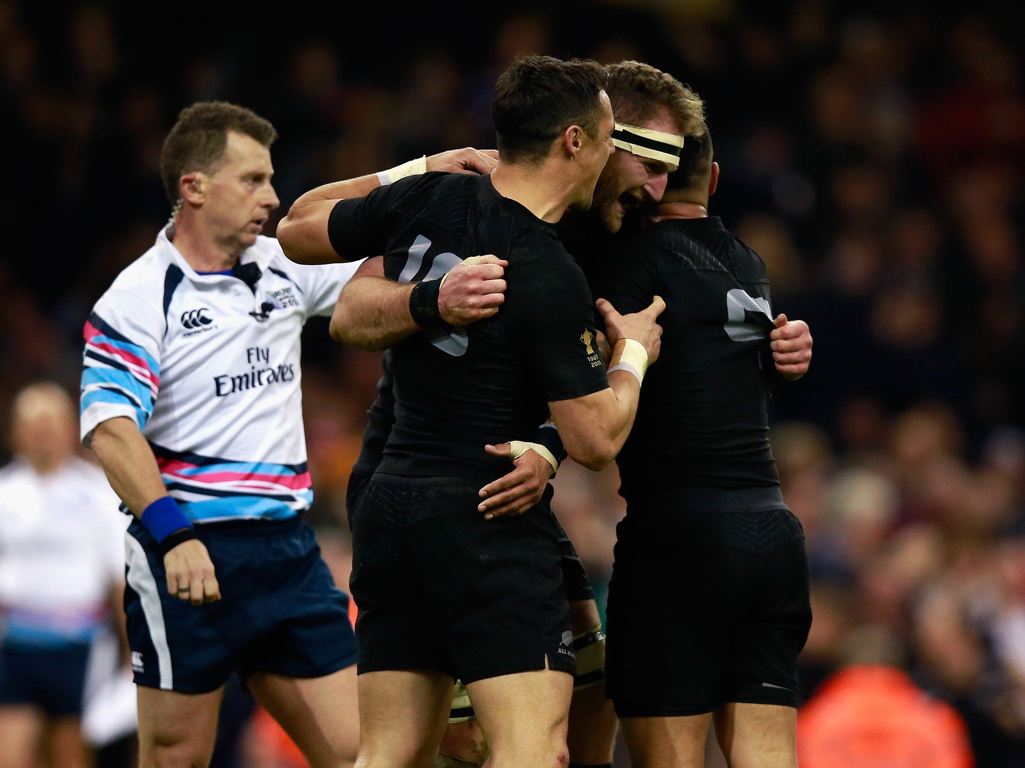 New Zealand players Dan carter and Aaron Smith celebrate with Kieran Read after he scores a try against France