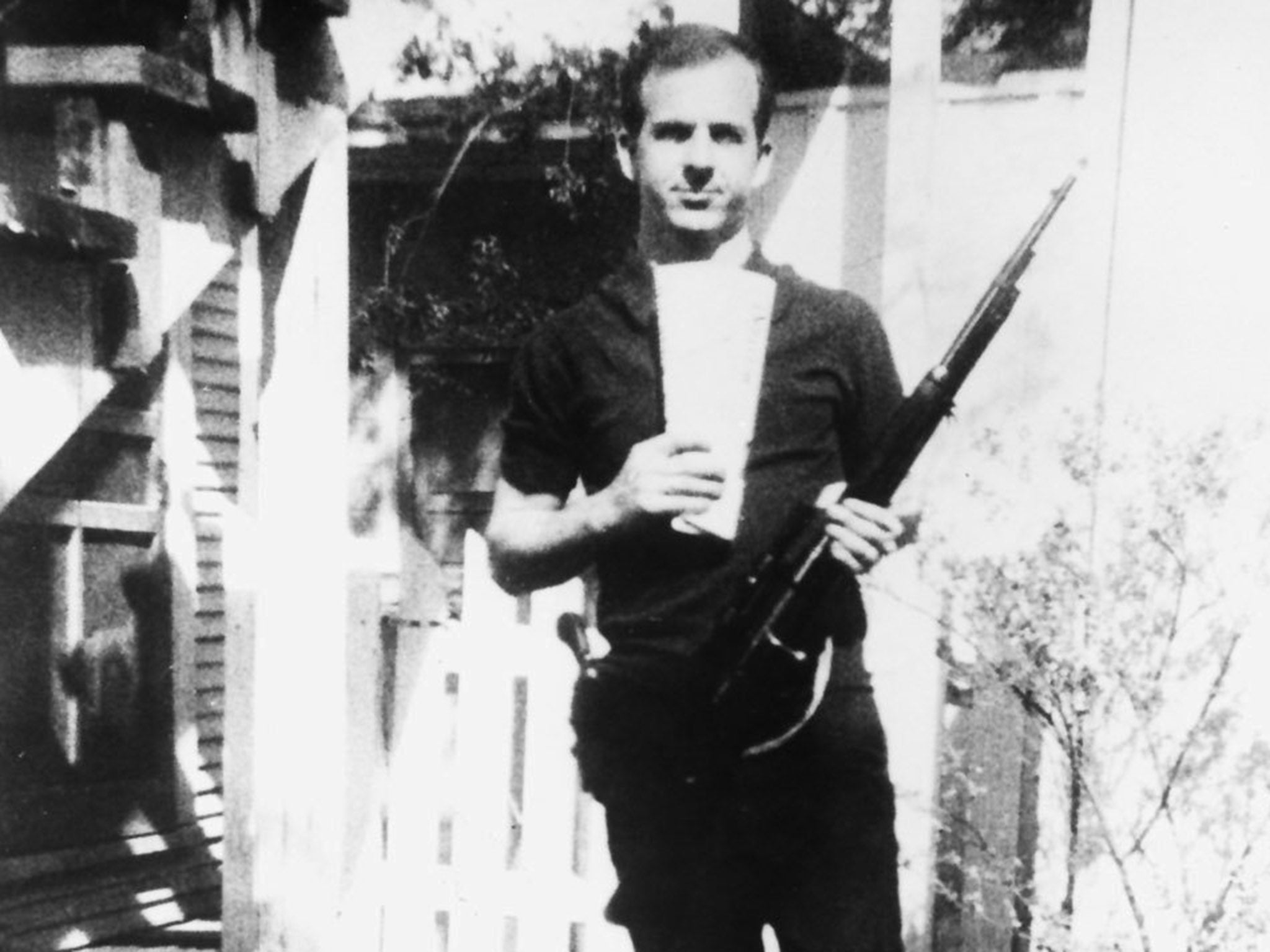 In this photo taken by his wife Marina, Lee Harvey Oswald poses with the Mannlicher–Carcano rifle he would later use to assassinate President John F Kennedy