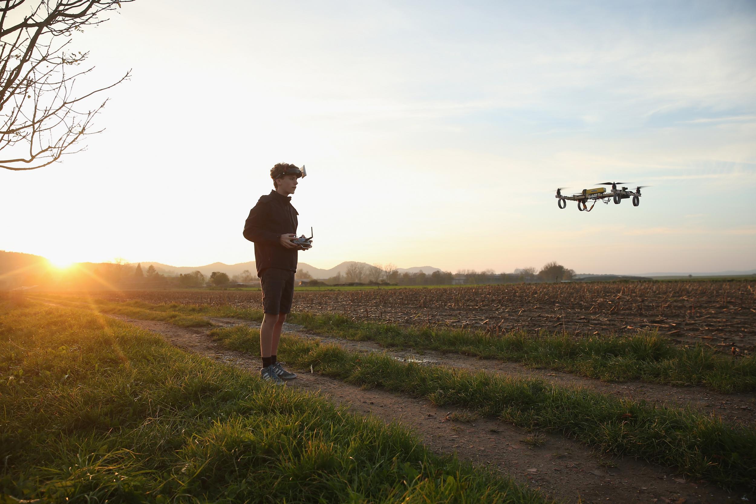 A boy flies a drone fitted with a camera, allowing him to have a first-person view from the drone during flight