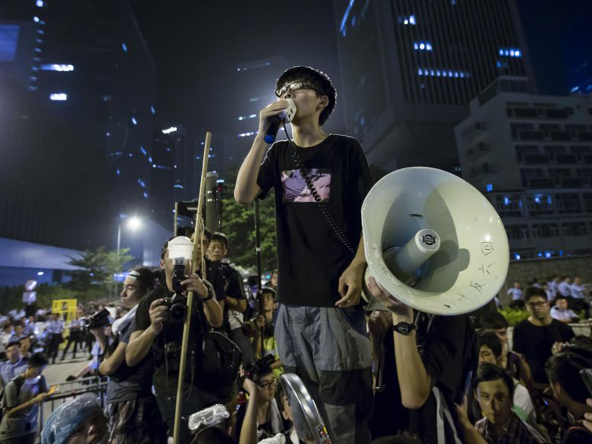 Joshua Wong delivering a speech outside the offices of Hong Kong's Chief Executive in October last year. Protestors captured the world’s attention when they occupied streets for 79 days and tried to storm the government headquarters