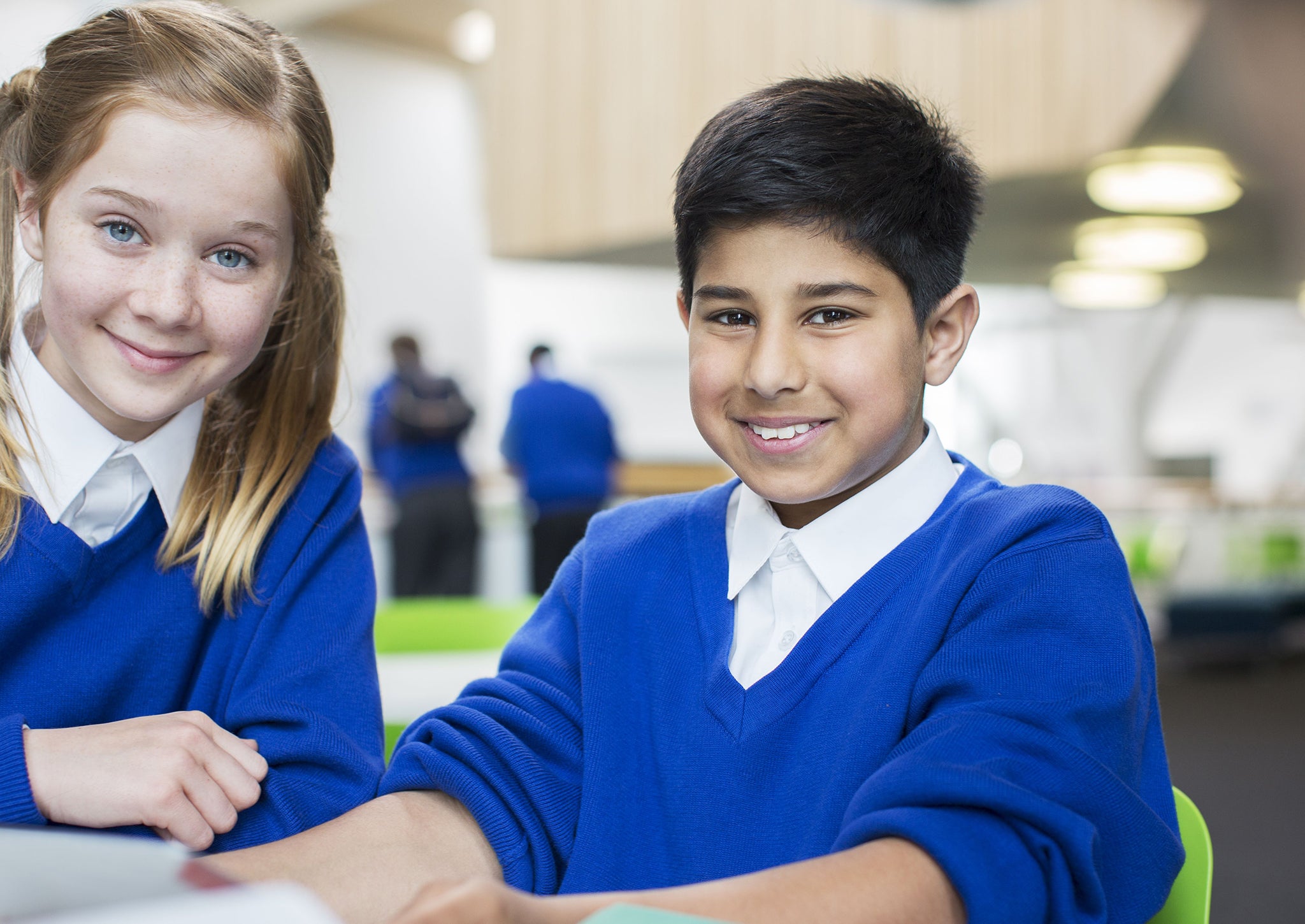 Two radiant schoolchildren beam for the camera